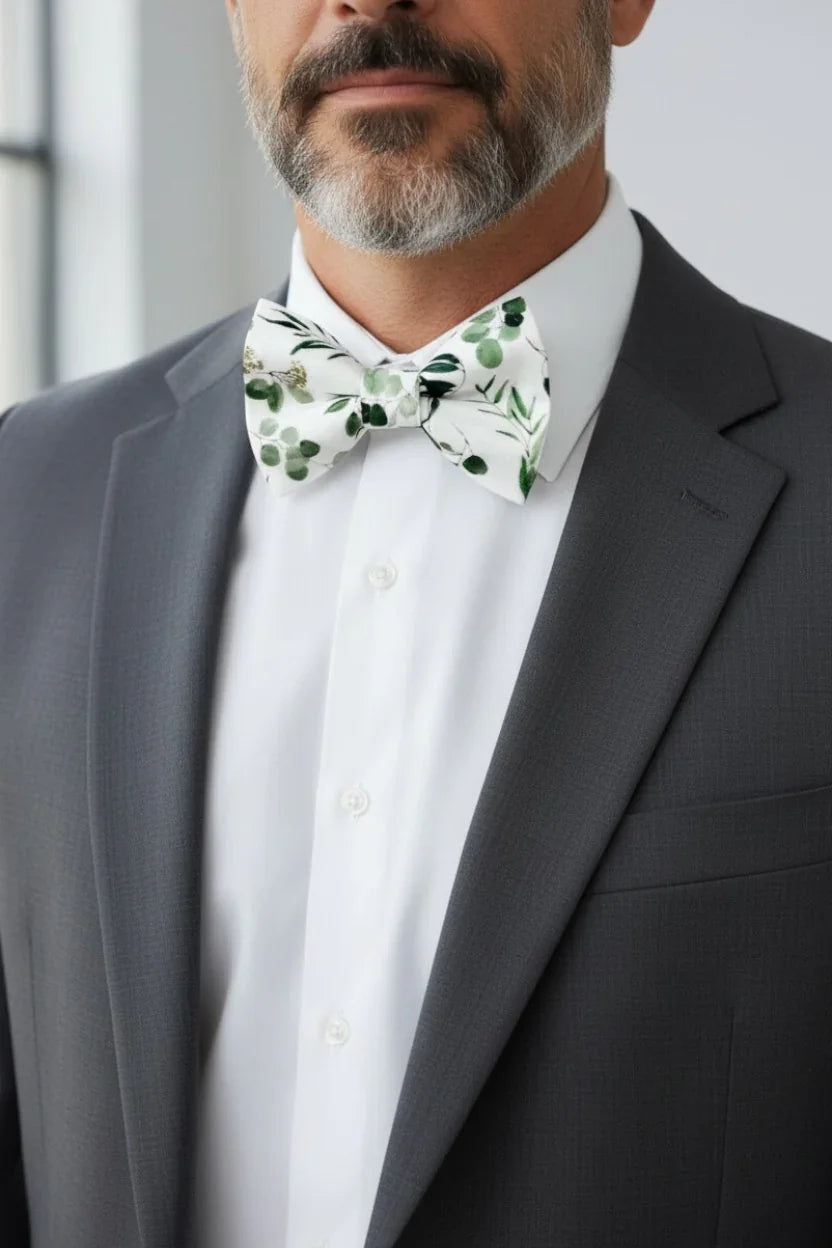 Floral bow tie for men worn by a man at a wedding.