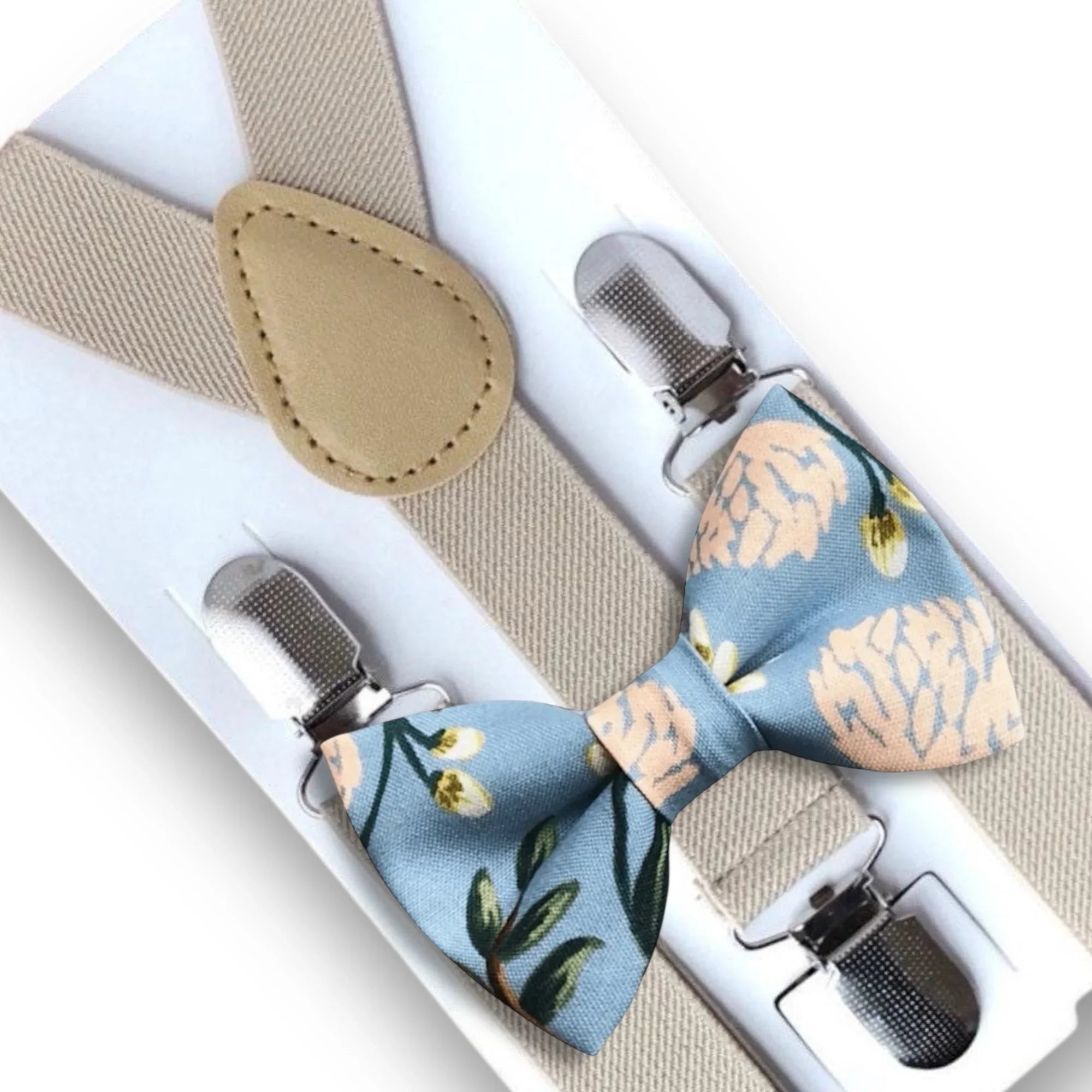 Size chart for suspender and bow tie sets from The Bold Bow Tie. Small (6mo-6yr): 18"-29" suspenders, 3.5" bow. Medium (7-12yr): 25.5"-40" suspenders, 4" bow. Adult (13yr-6ft tall): 25.5"-40" suspenders, 4.5" bow. Big & Tall (Over 6ft tall): 31"-53" suspenders, 4.5" bow. Instructions note to measure from the back waistband over the shoulder to the front waistband for a comfortable fit.