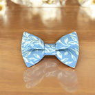 Blue & White Floral Bow Tie for groomsmen, wedding party and ring bearers on a wooden table.