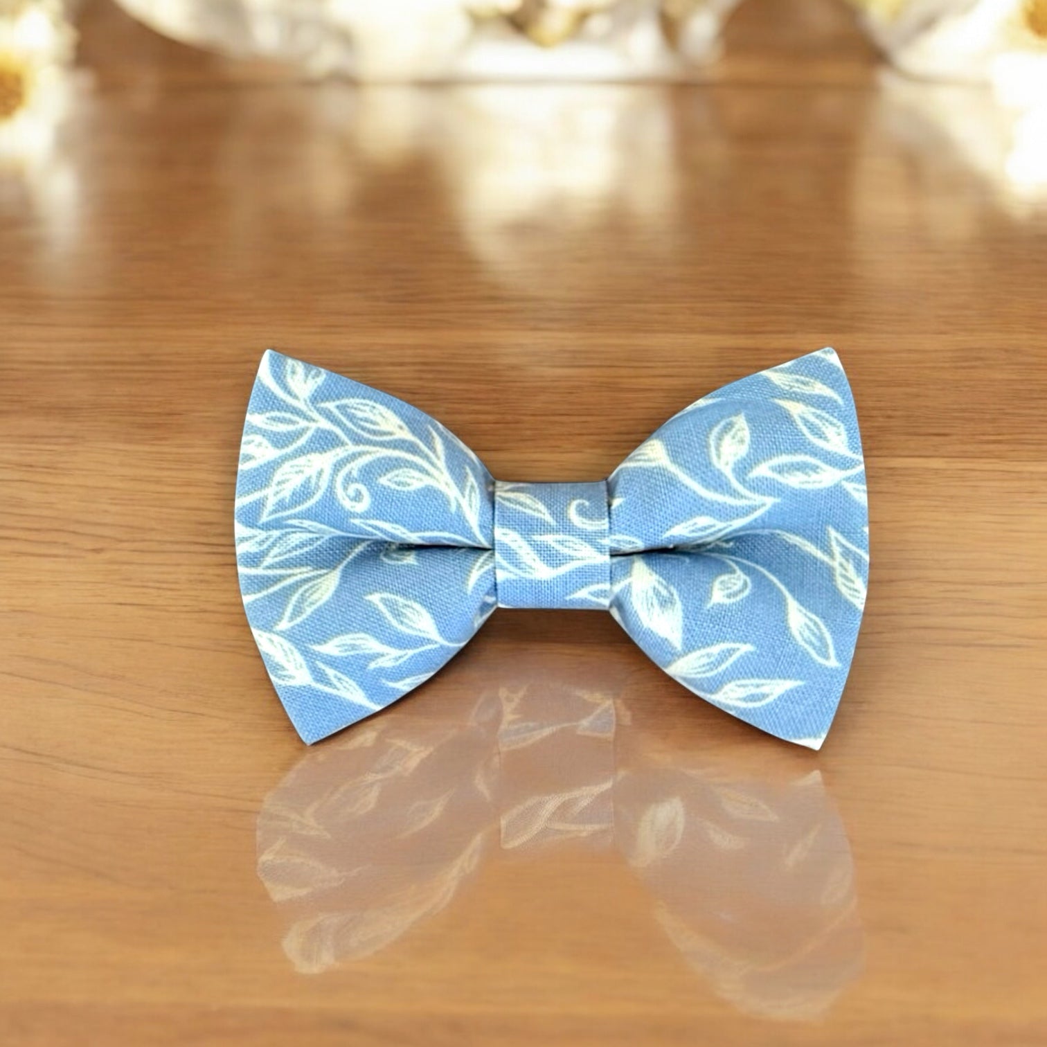 Blue & White Floral Bow Tie for groomsmen, wedding party and ring bearers on a wooden table.