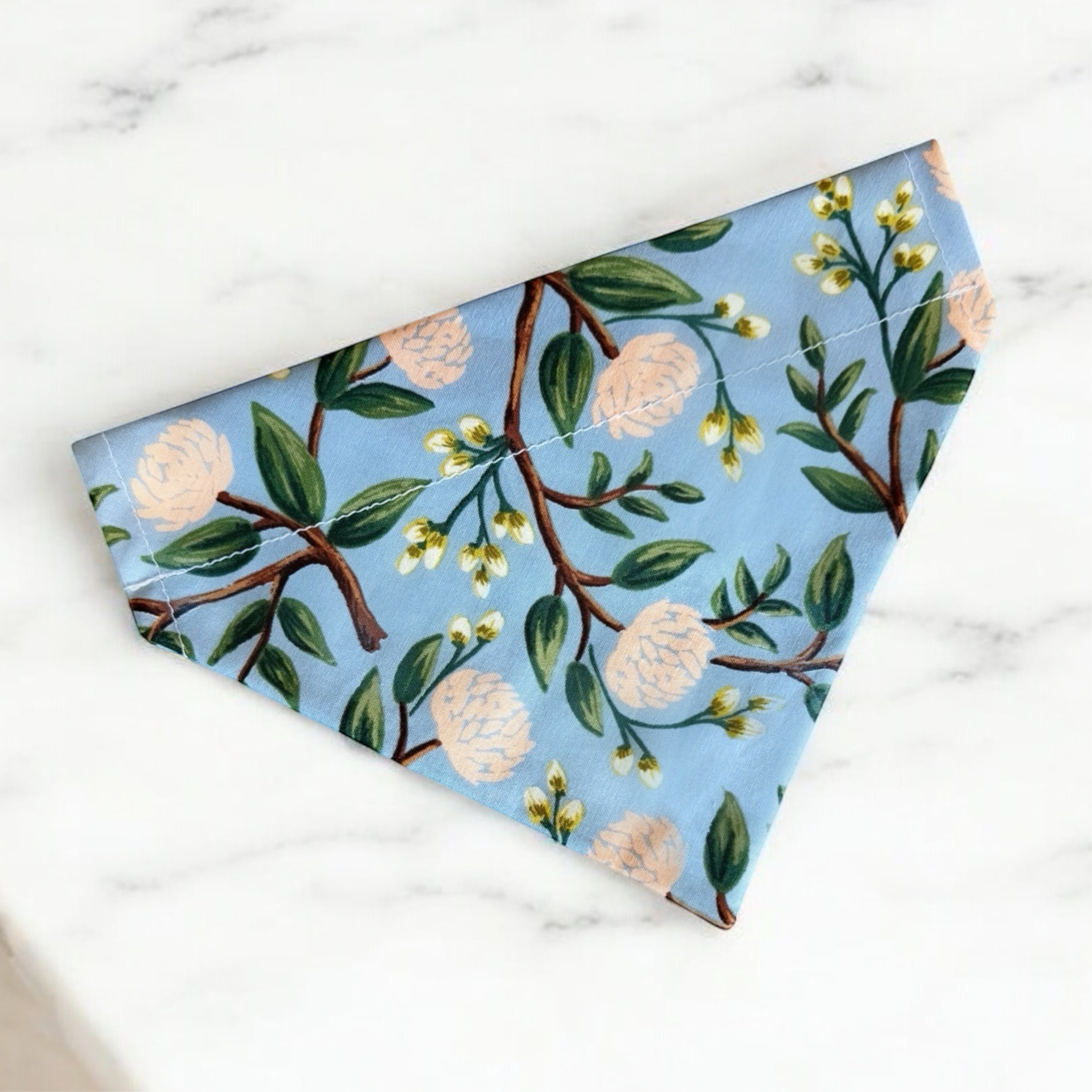 Floral Dusty Blue Dog Bandana- for summer or dog wedding outfit on a white marble table.