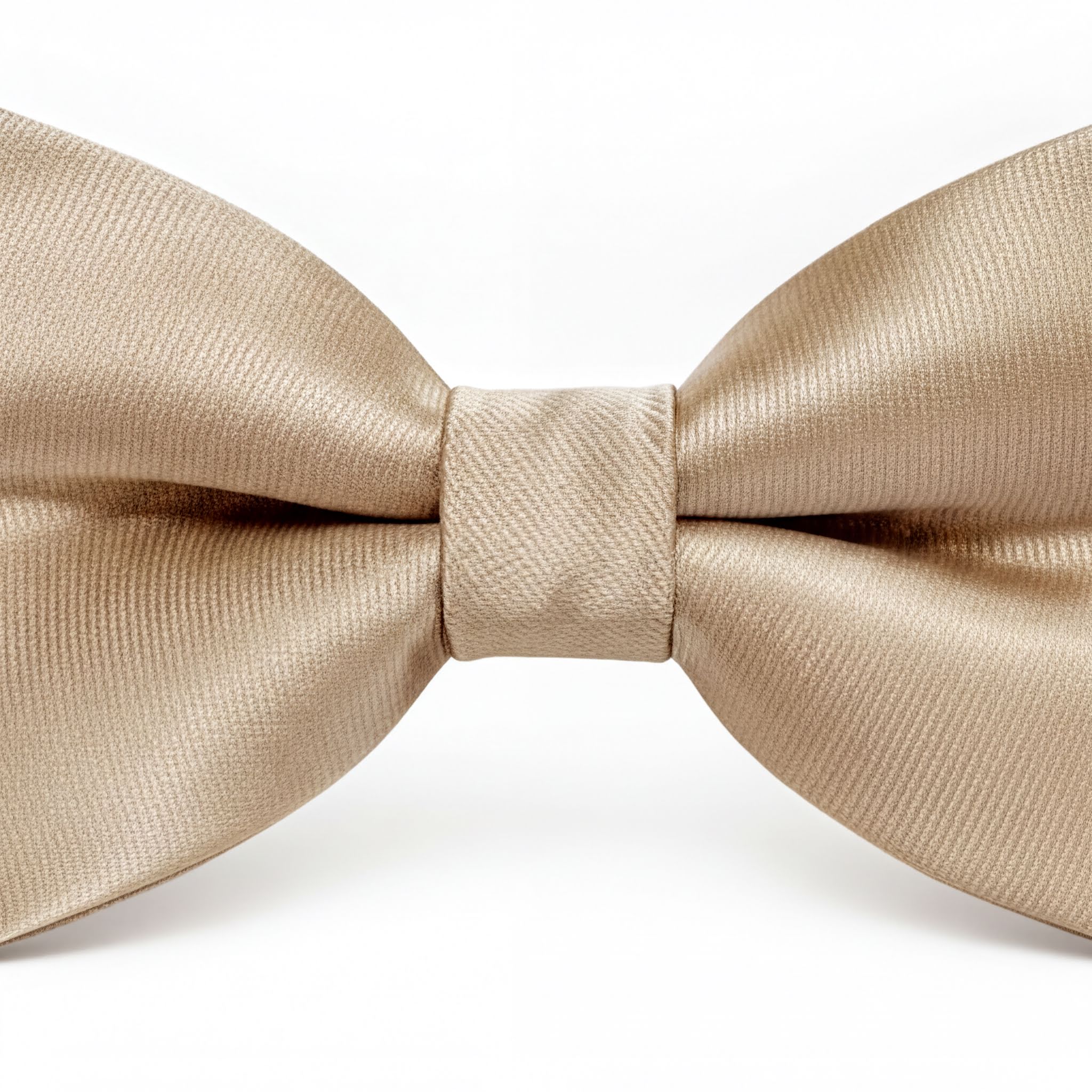 A close-up image of a beige bow tie against a white background.