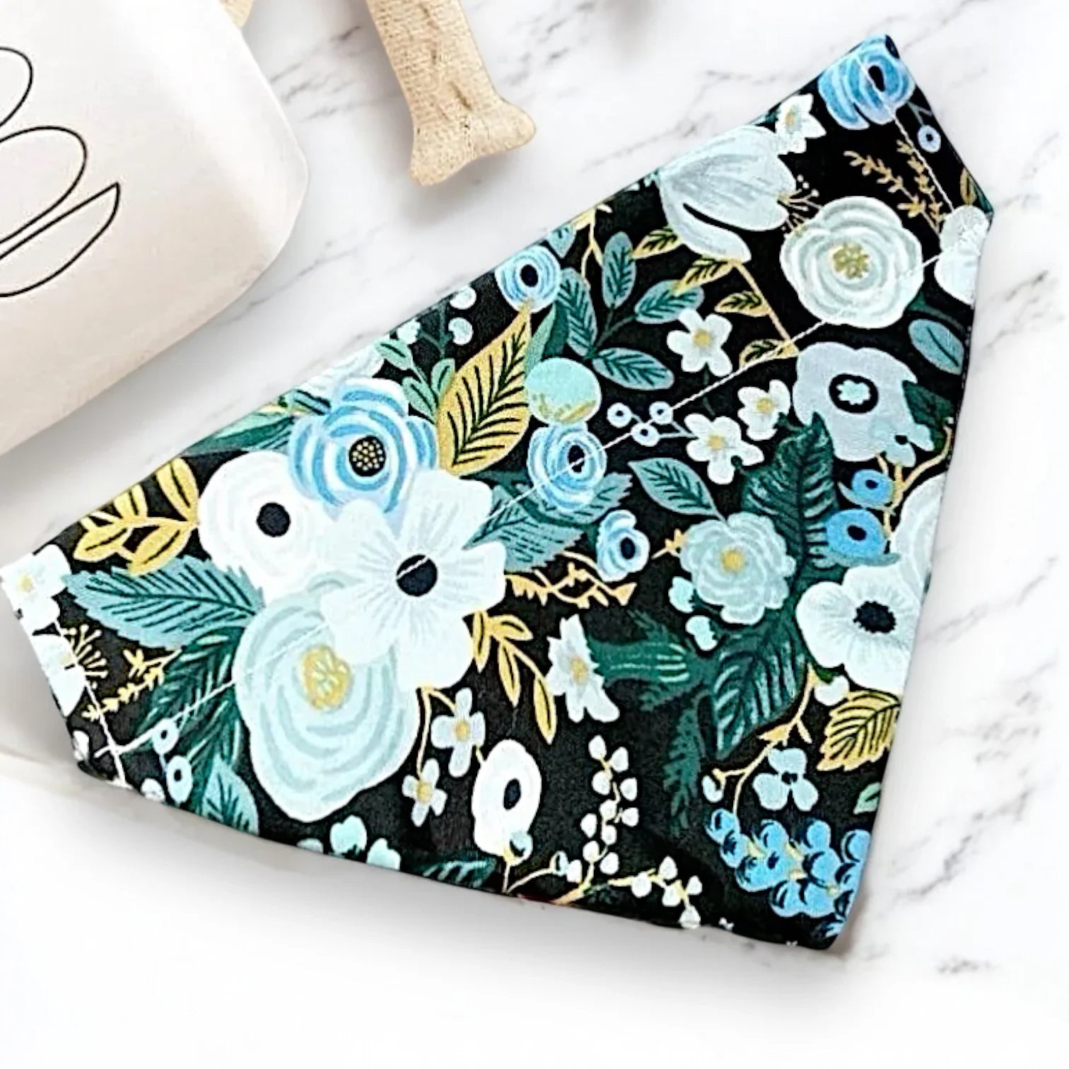 Blue floral Rifle Paper Co fabric dog or cat bandana on a marble surface