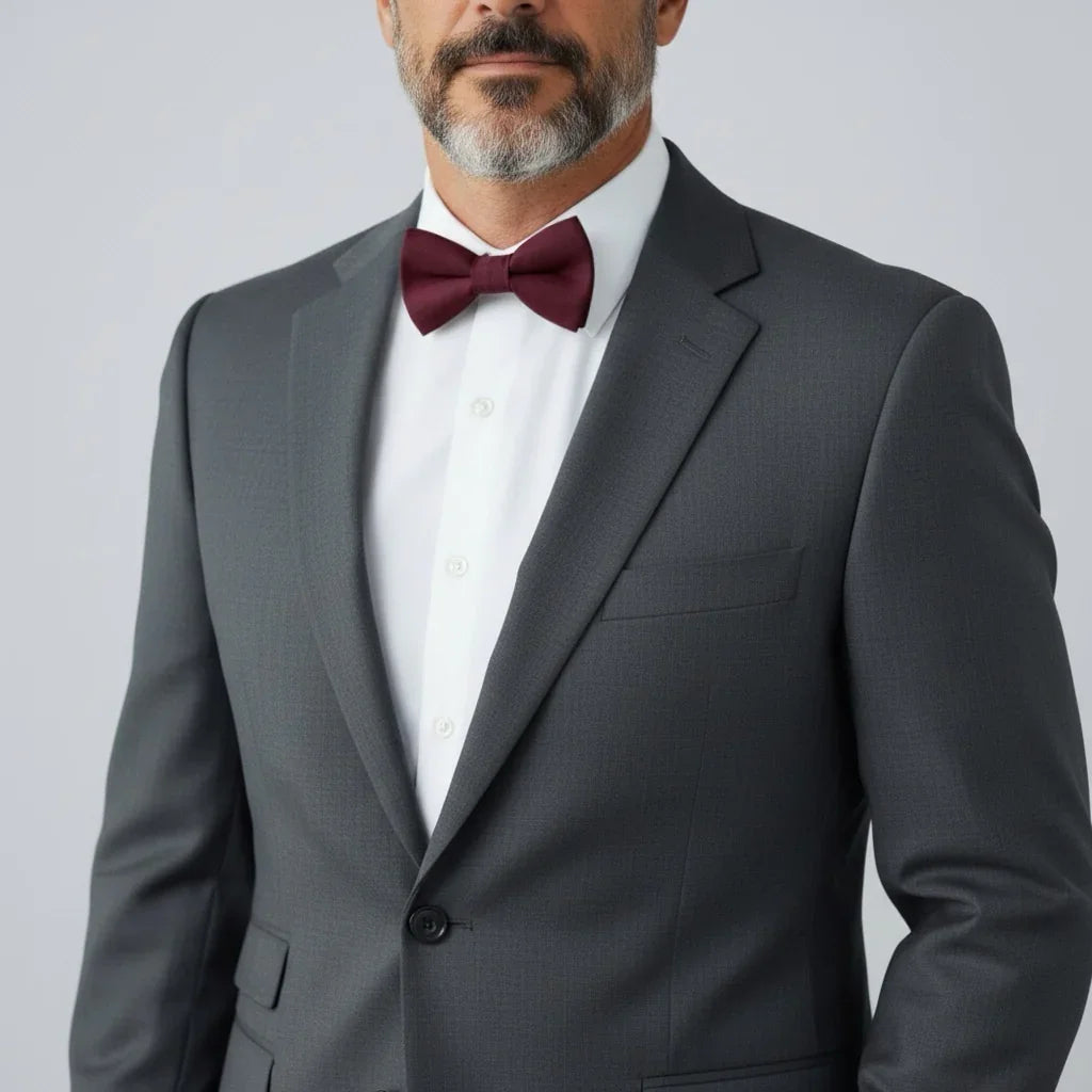 Burgundy bow tie worn by a man going to a wedding.