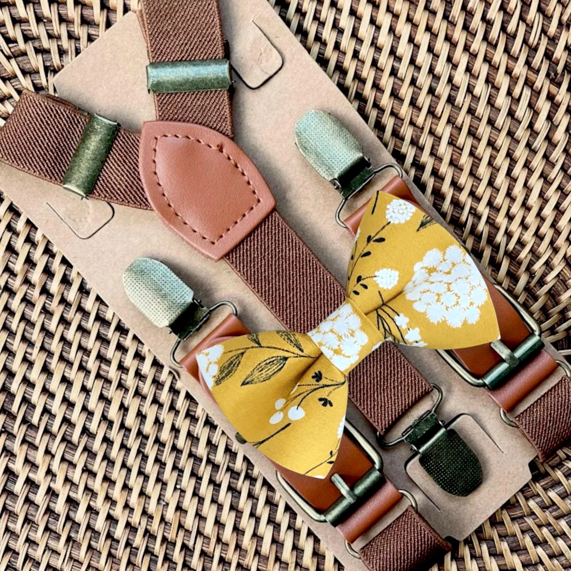 Floral bow tie and suspenders in yellow and brown.