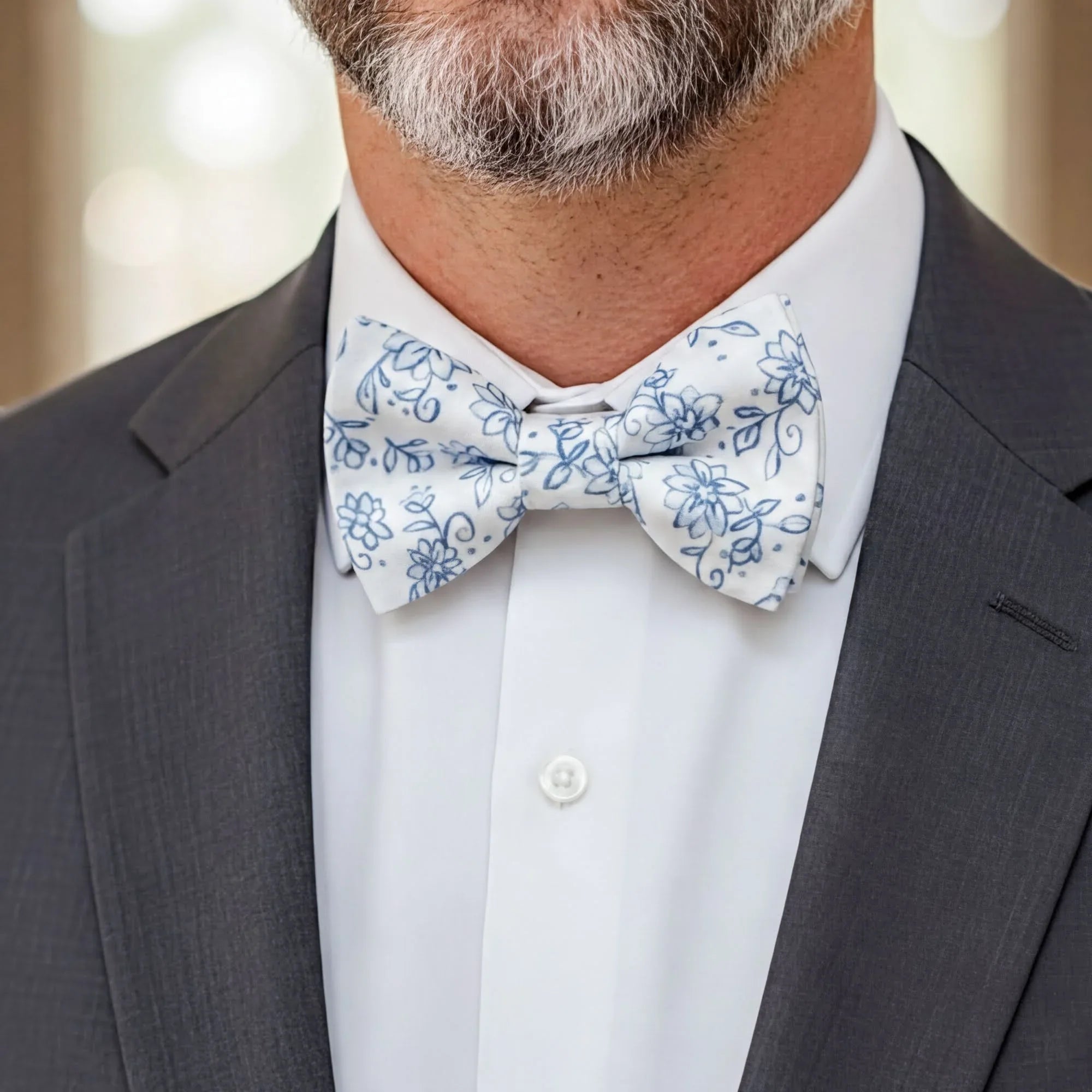 Size chart for pre-tied bow ties from The Bold Bow Tie detailing measurements across three sizes. Small is 3.5 inches wide and recommended for ages 6 months to 5 years. Medium is 4 inches wide and recommended for ages 6 to 12 years. Large is 4.5 inches wide and recommended for ages 13 years and up. Visual icons illustrate the relative sizes with horizontal arrows showing that width is measured from wingtip to wingtip. Bottom text notes that all bow ties are pre-tied and ready to add to your outfit.