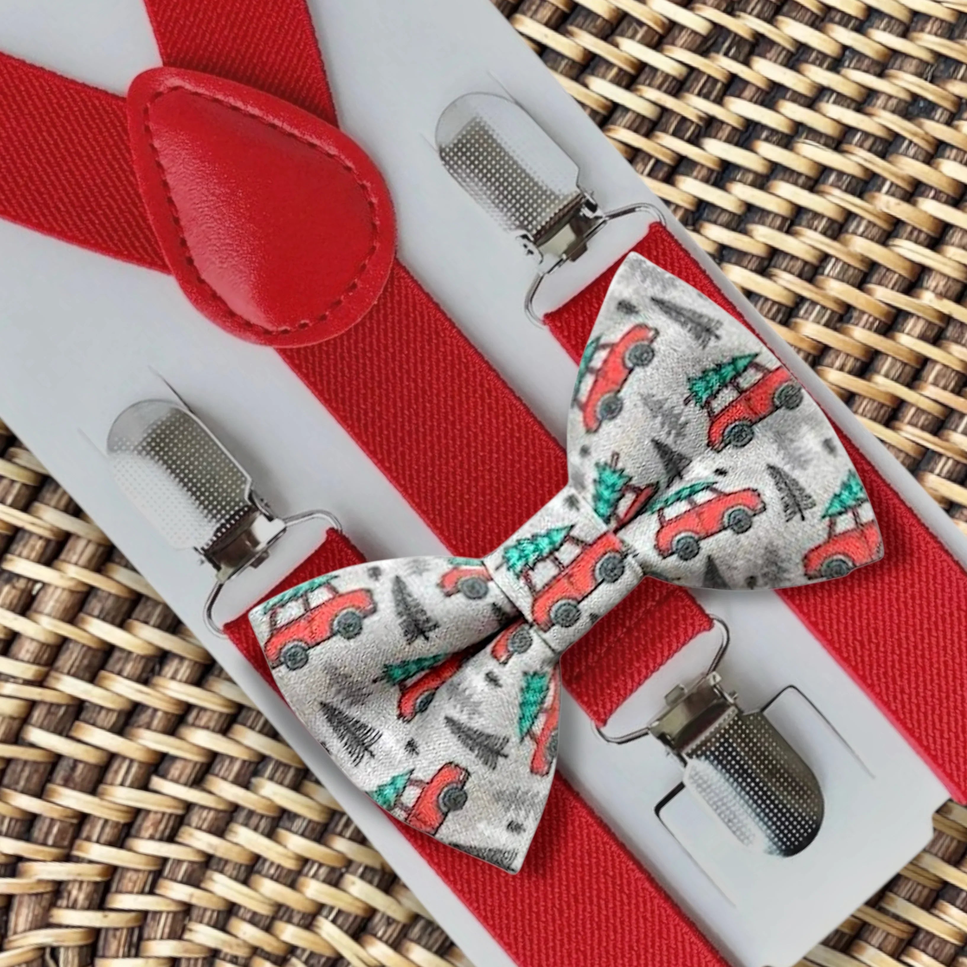 Red suspenders with matching red bow tie displayed on a gift card with metal clips