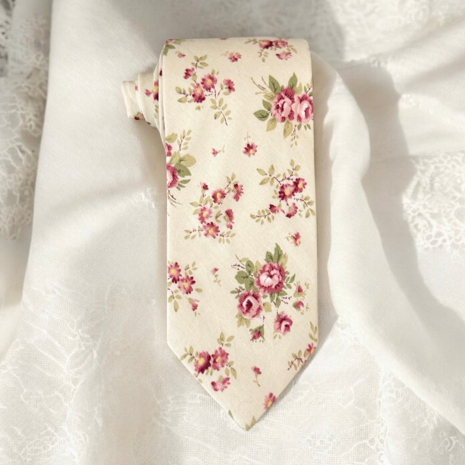 Floral patterned tie on a white fabric background