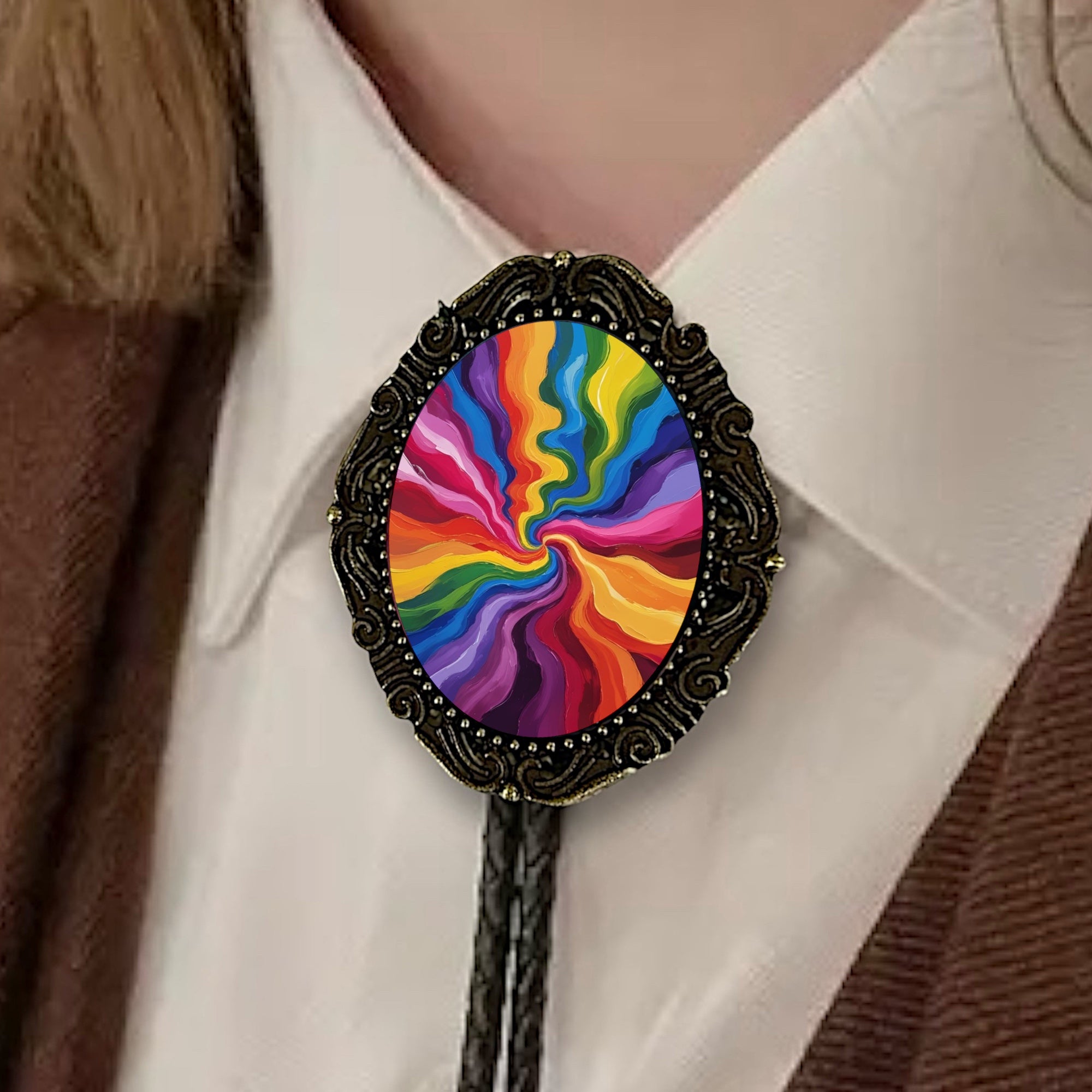 Colorful spiral design bolo tie on a person wearing a white shirt and brown jacket.