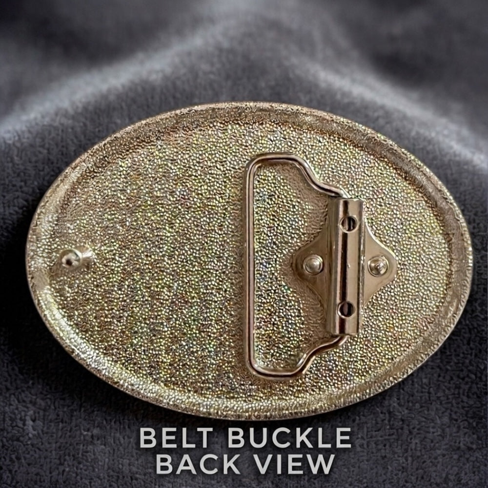 a close-up view of a shiny, metallic belt buckle with a textured surface.