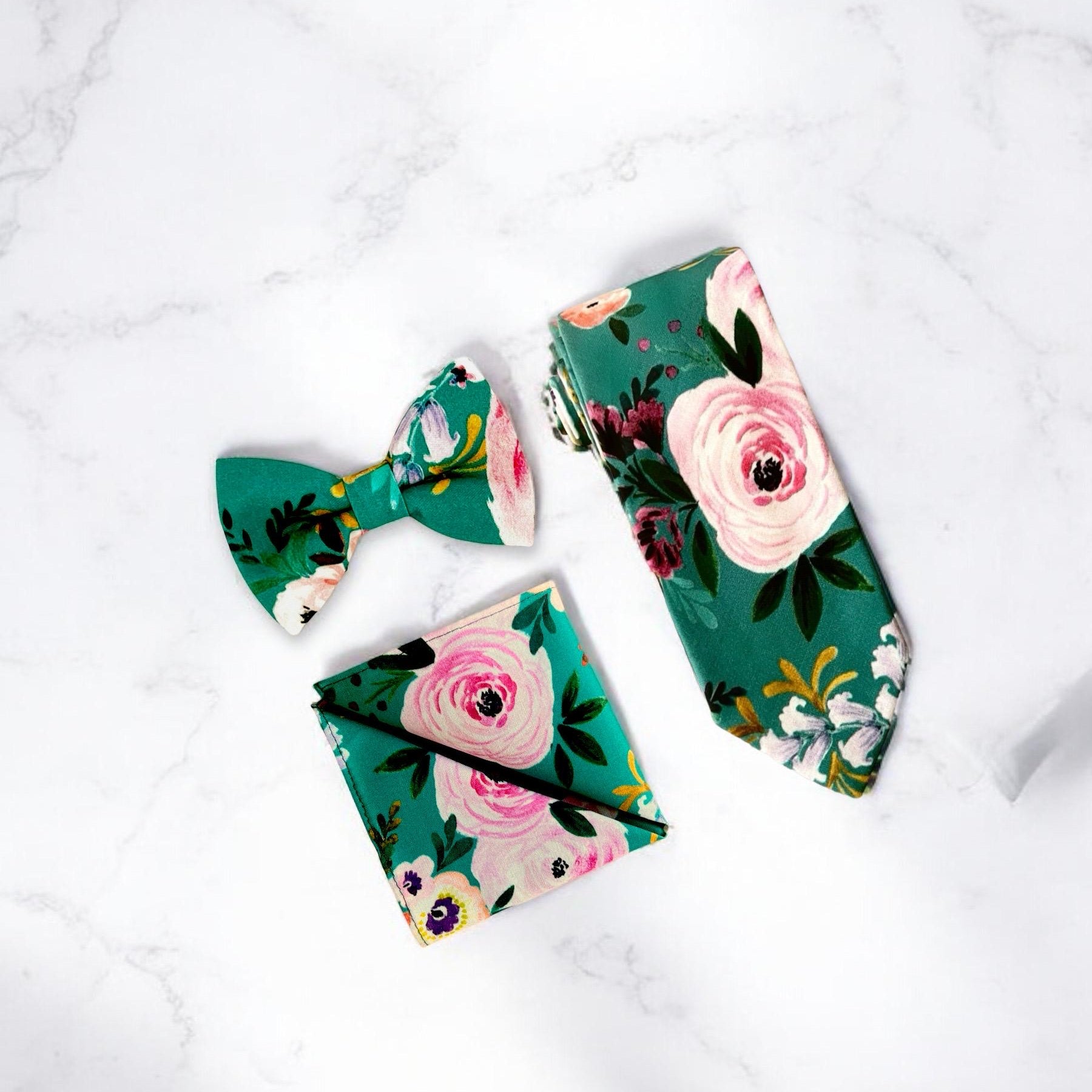 Teal floral necktie for men for wedding on a white marble counter