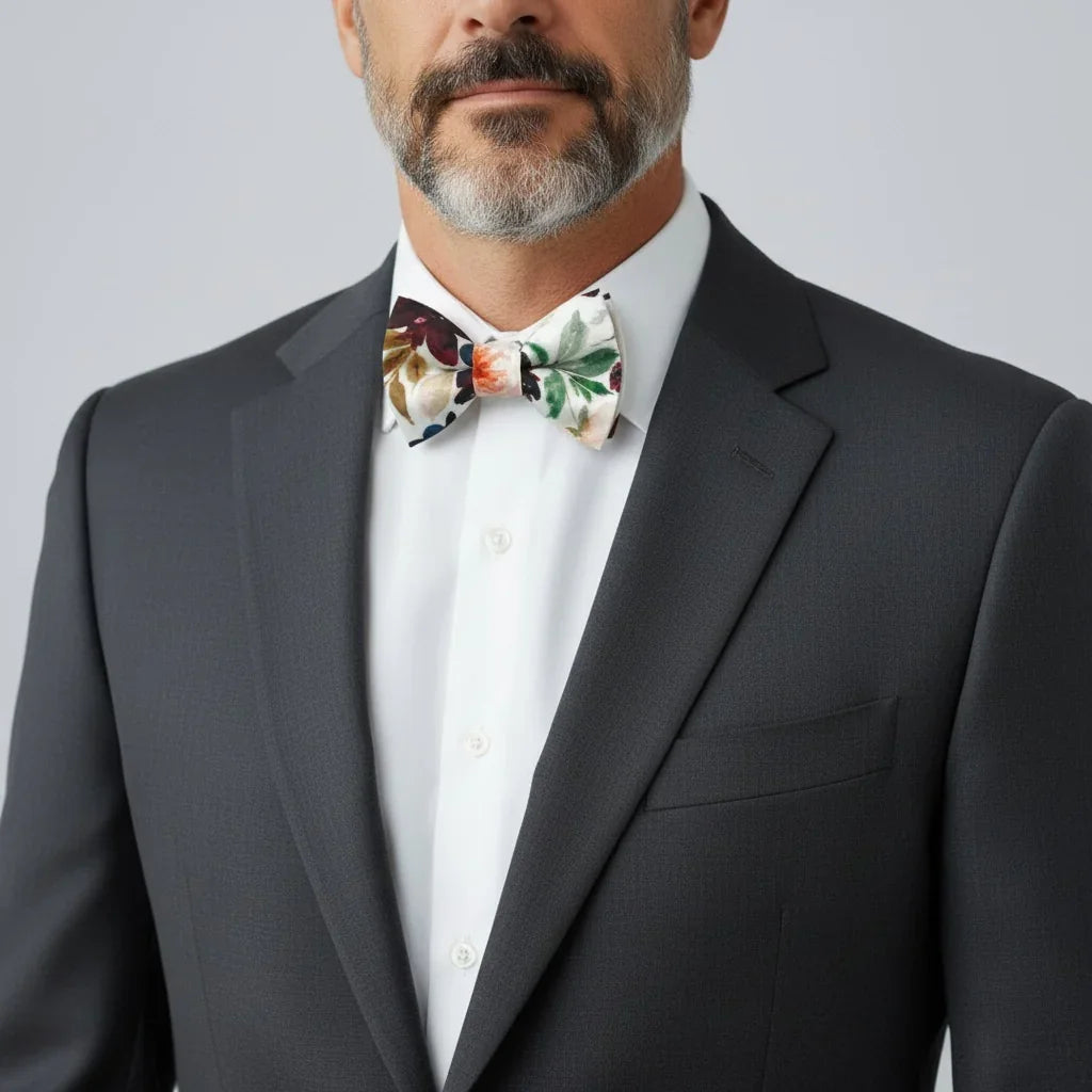 Floral bowtie worn by a man in a suit.
