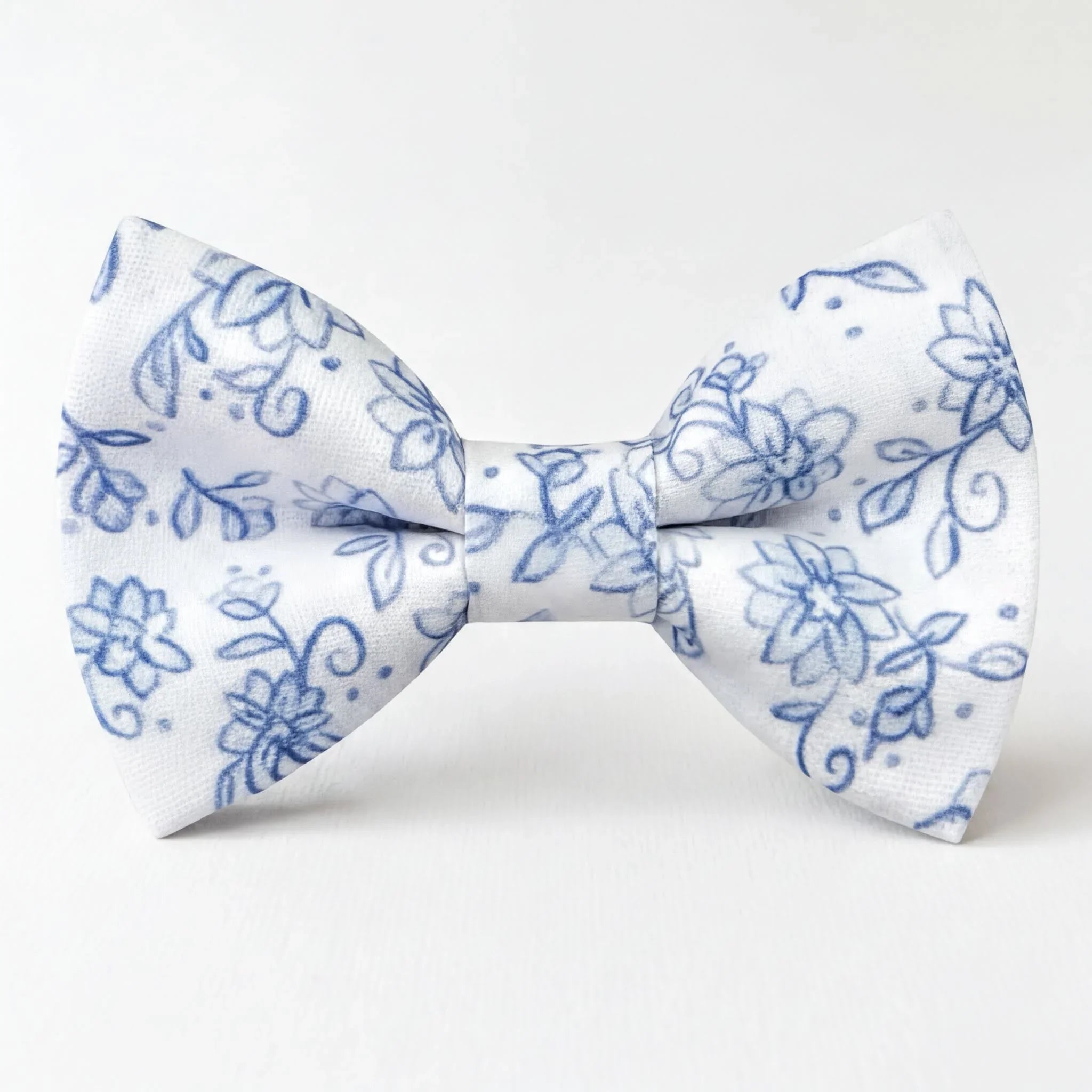 A white and blue floral mens bow tie with a blue floral pattern.