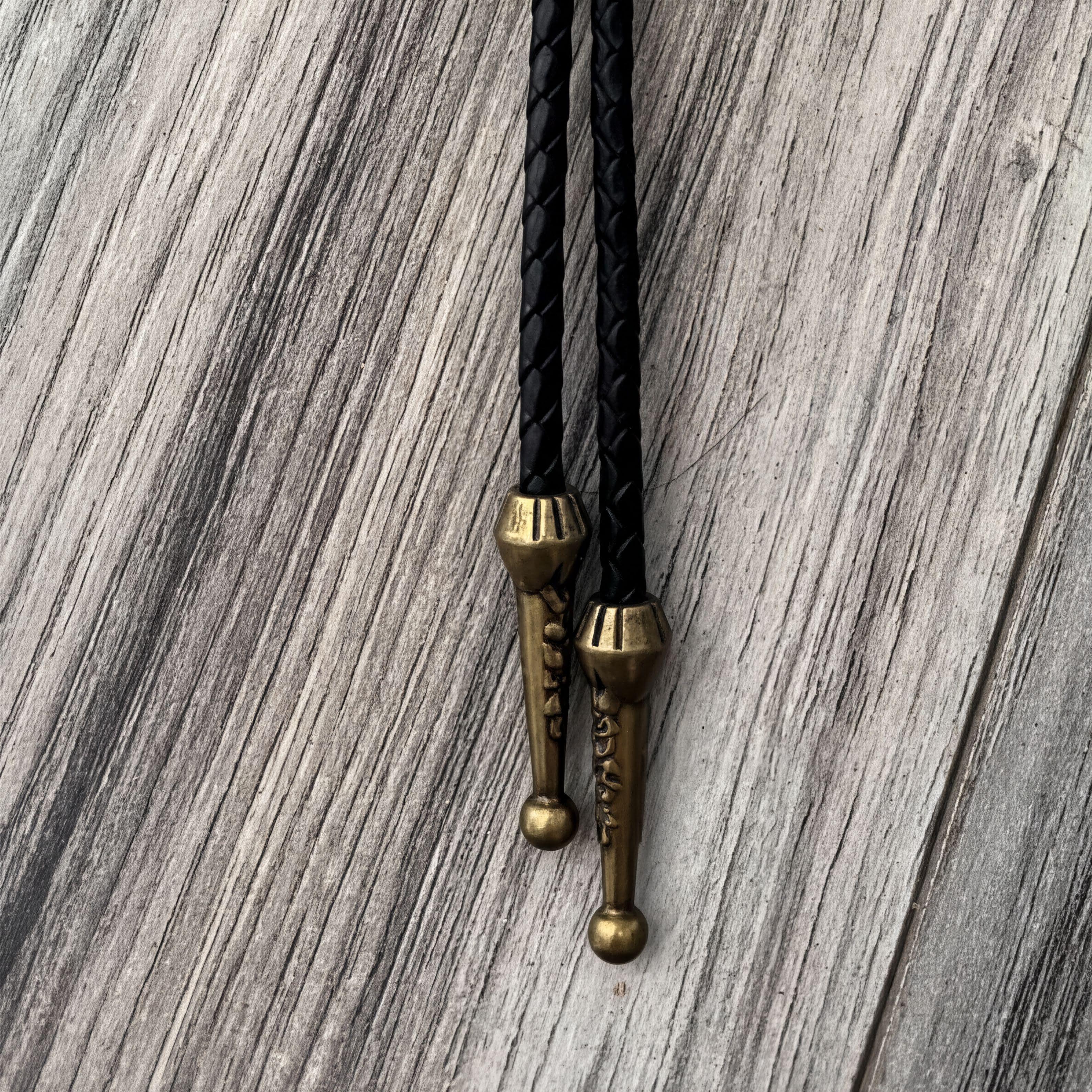 Bolo tie tassels in bronze.