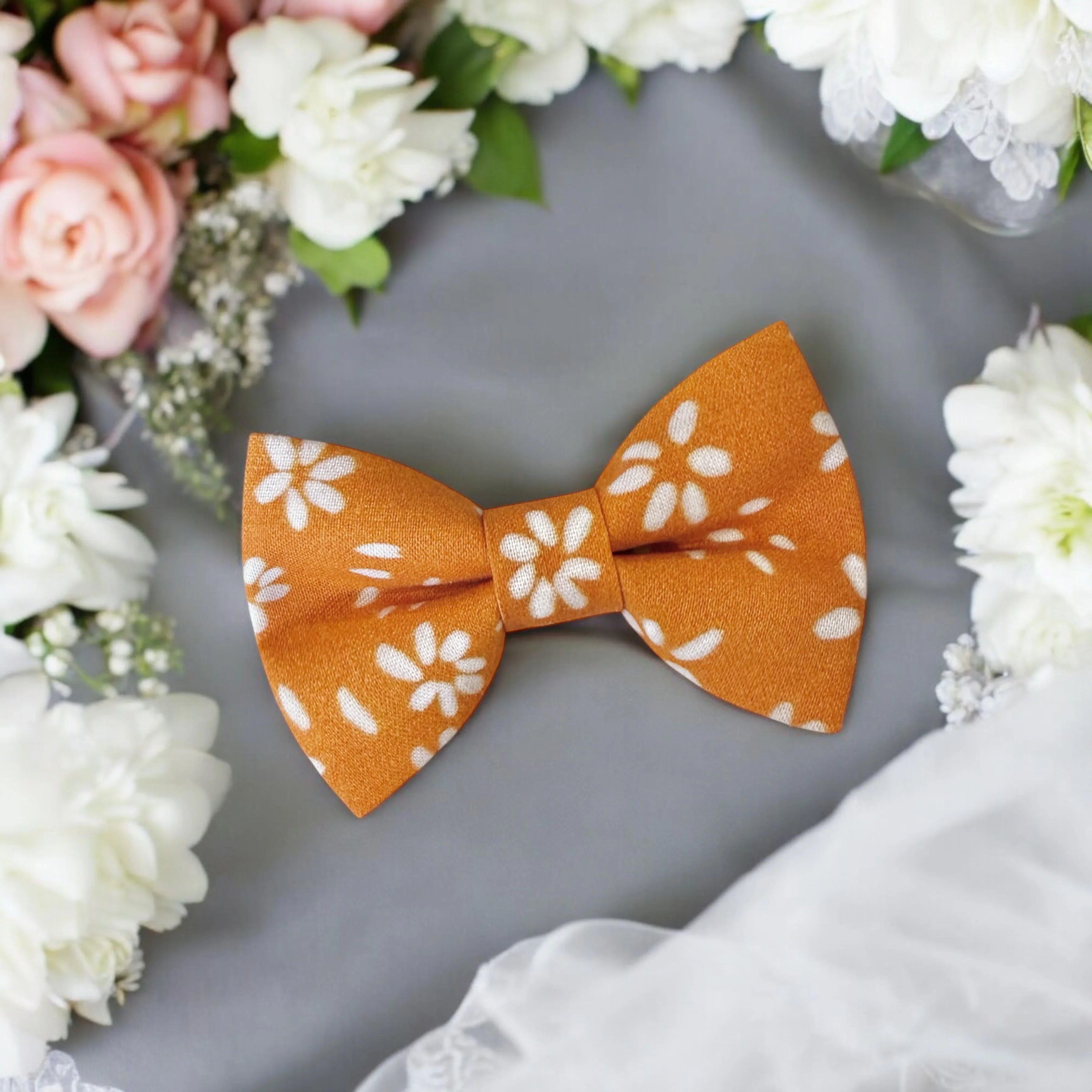 Size chart for pre-tied bow ties from The Bold Bow Tie detailing measurements across three sizes. Small is 3.5 inches wide and recommended for ages 6 months to 5 years. Medium is 4 inches wide and recommended for ages 6 to 12 years. Large is 4.5 inches wide and recommended for ages 13 years and up. Visual icons illustrate the relative sizes with horizontal arrows showing that width is measured from wingtip to wingtip. Bottom text notes that all bow ties are pre-tied and ready to add to your outfit.