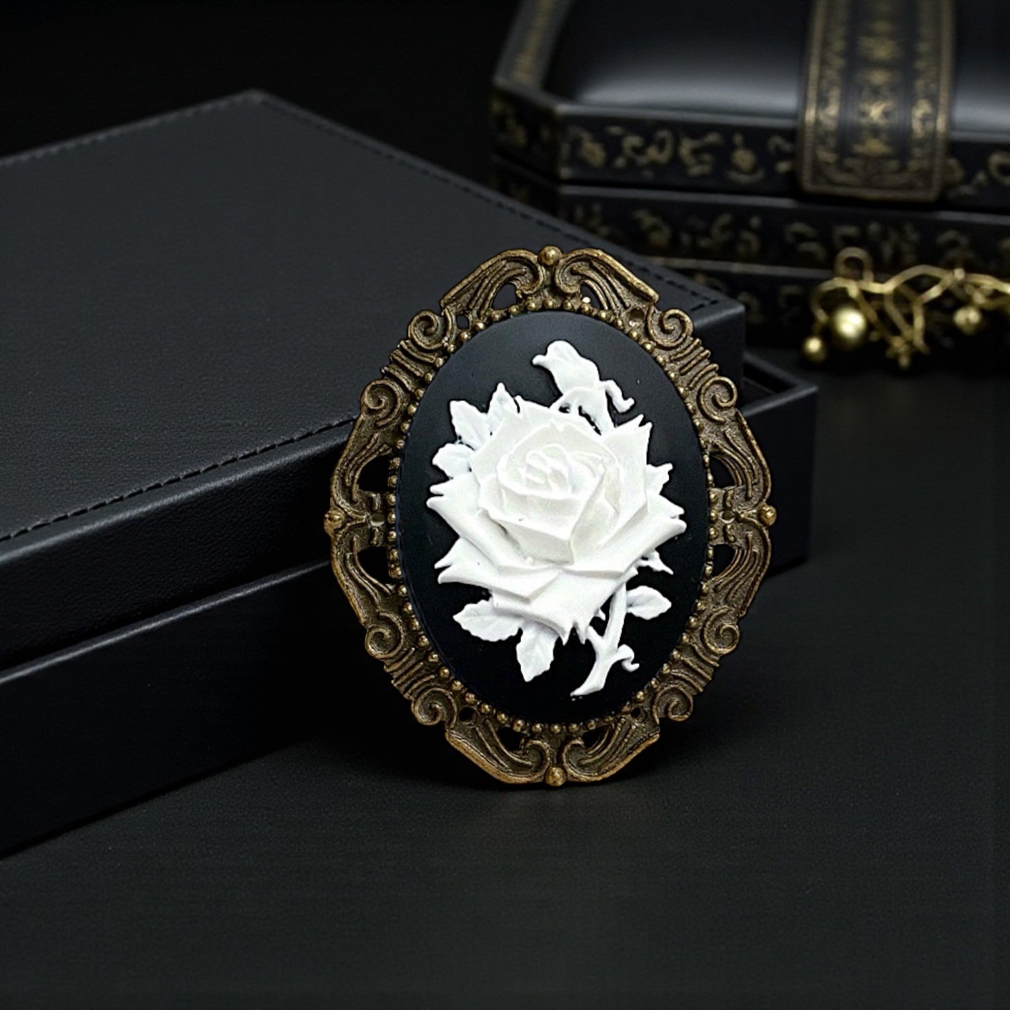 Decorative vintage brooch with white rose design on a black background
