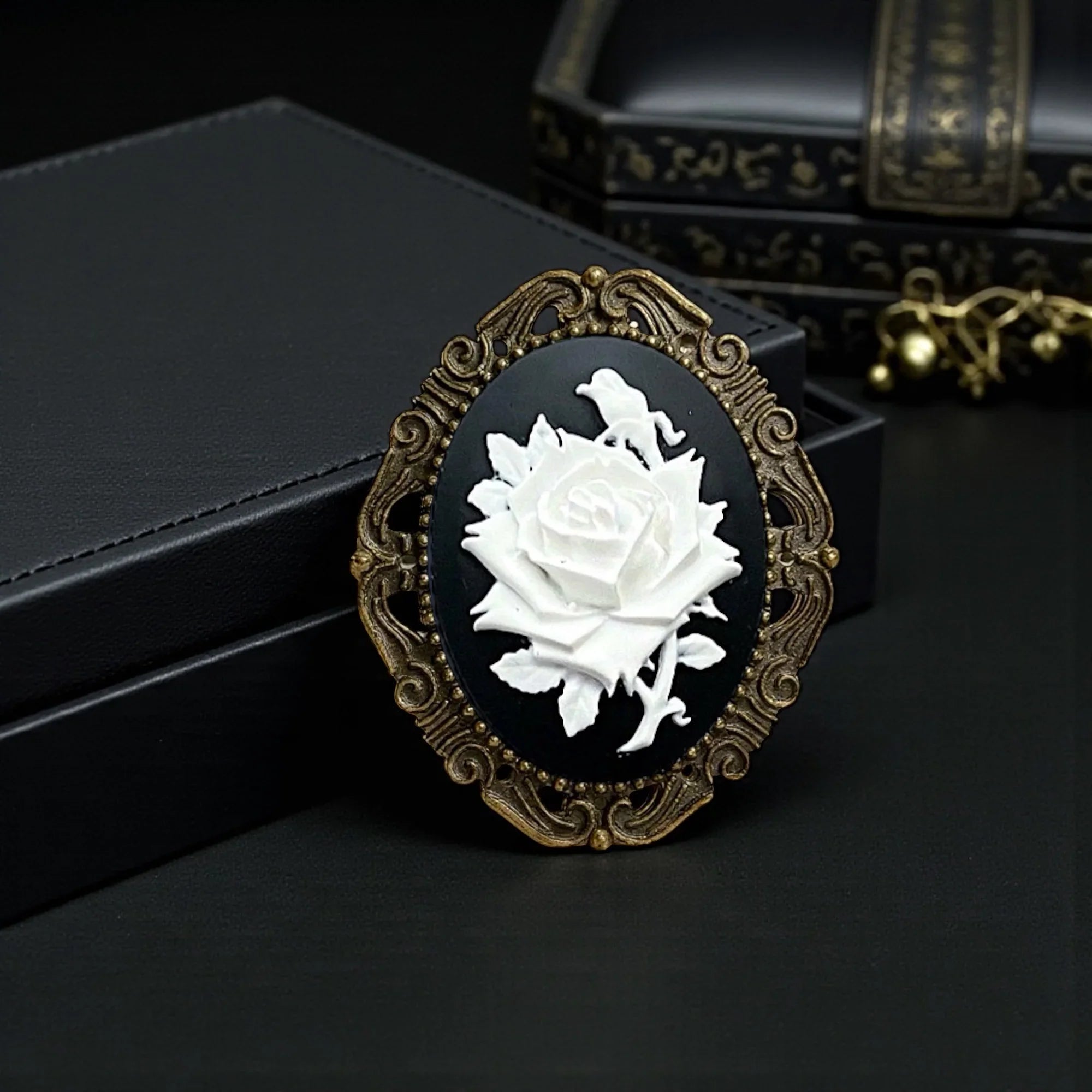 Decorative vintage brooch with white rose design on a black background