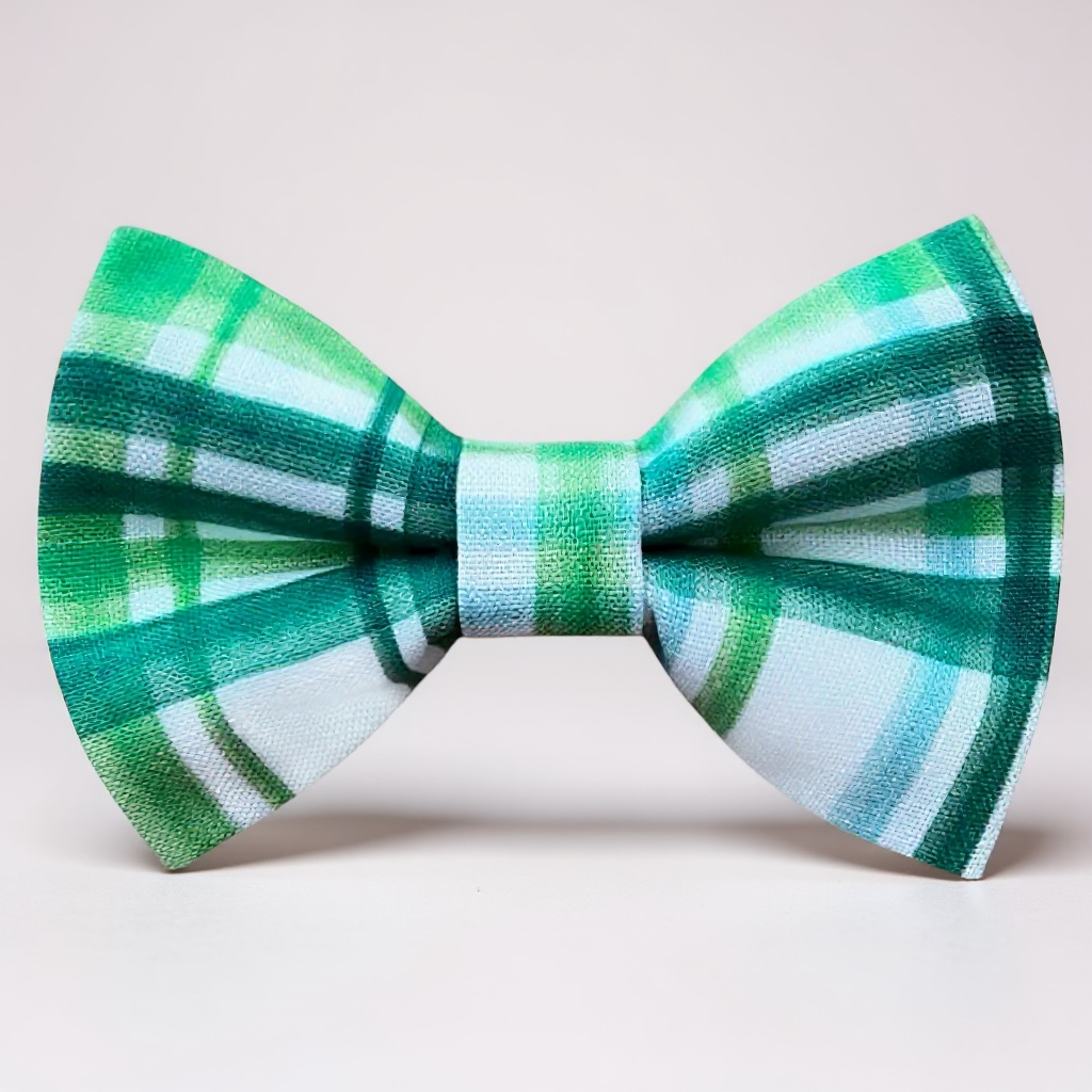 Green plaid bow tie on a light gray background for St. Patrick’s Day.
