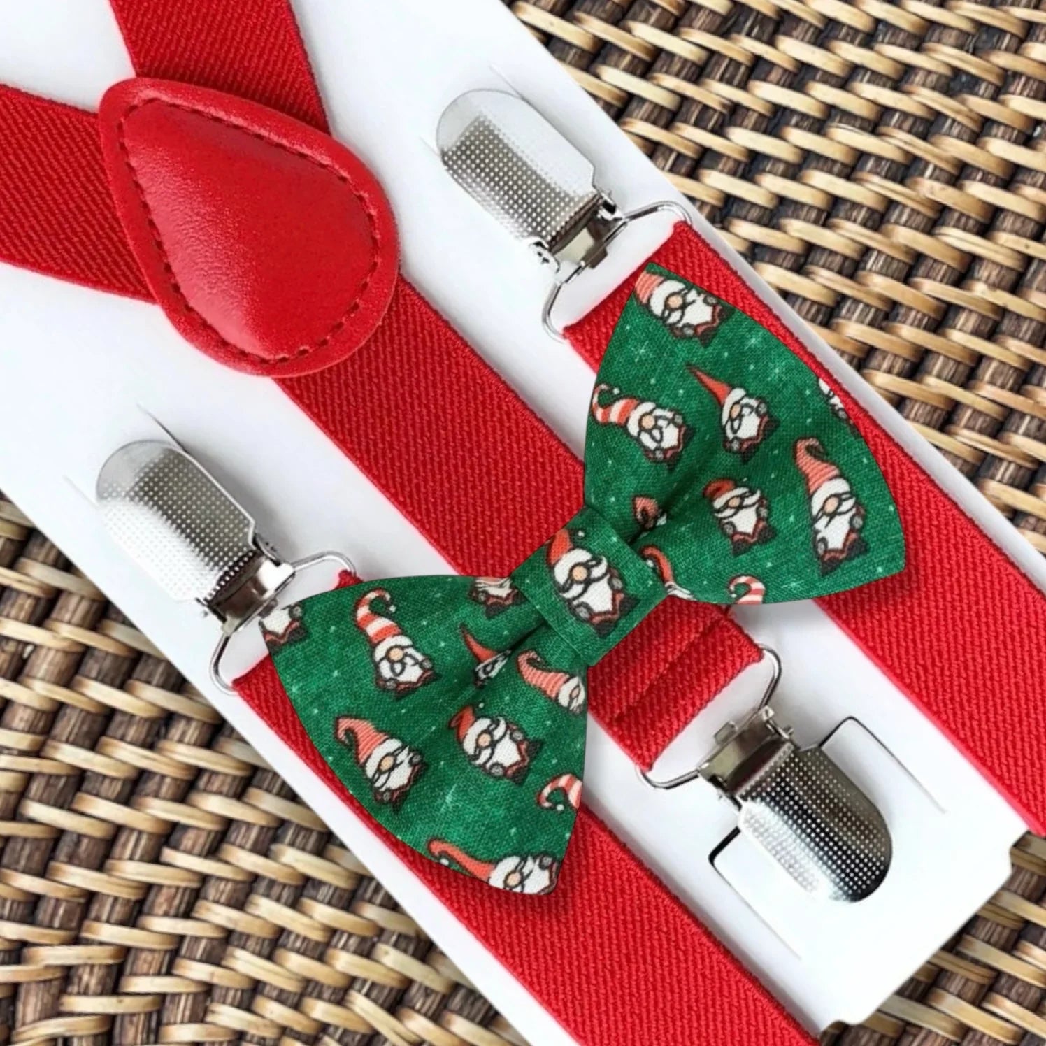 Green bow tie with a gnome pattern paired with red suspenders on a white display card