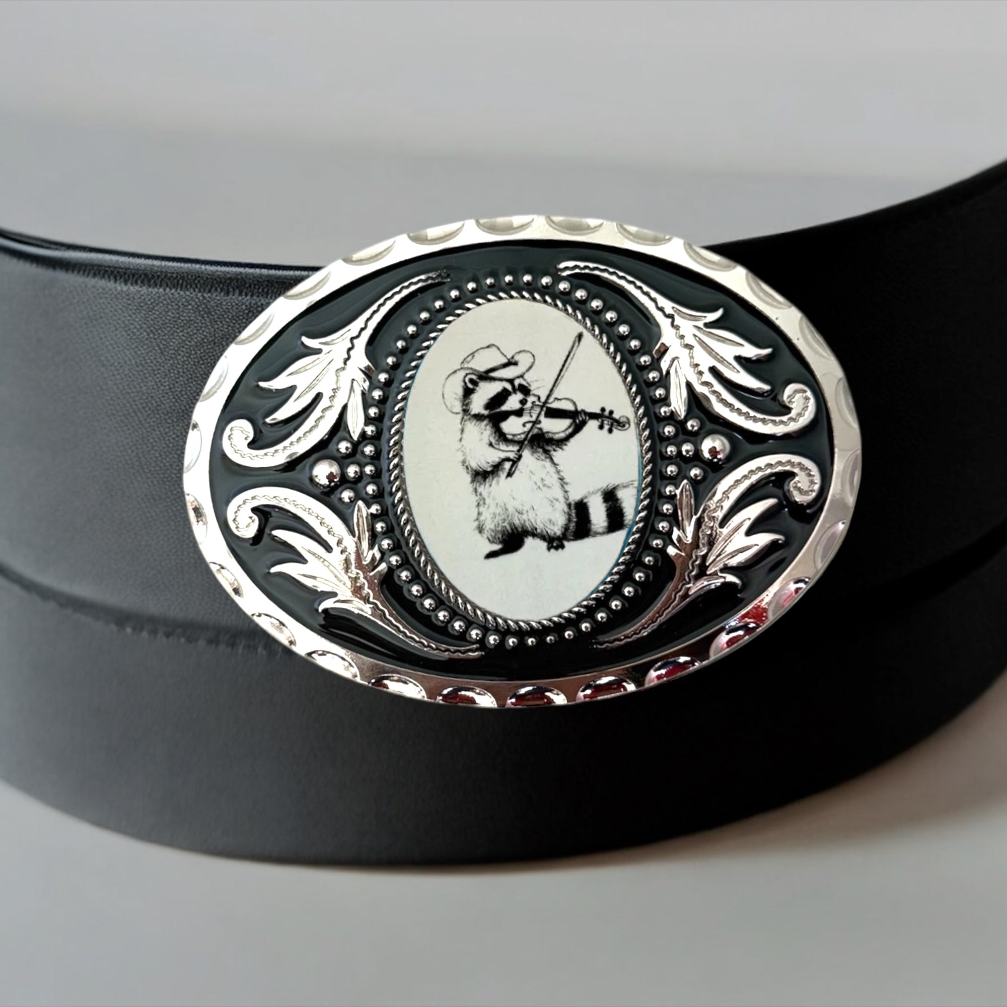 Raccoon Belt Buckle with Violin, Western Accessory on a black leather belt