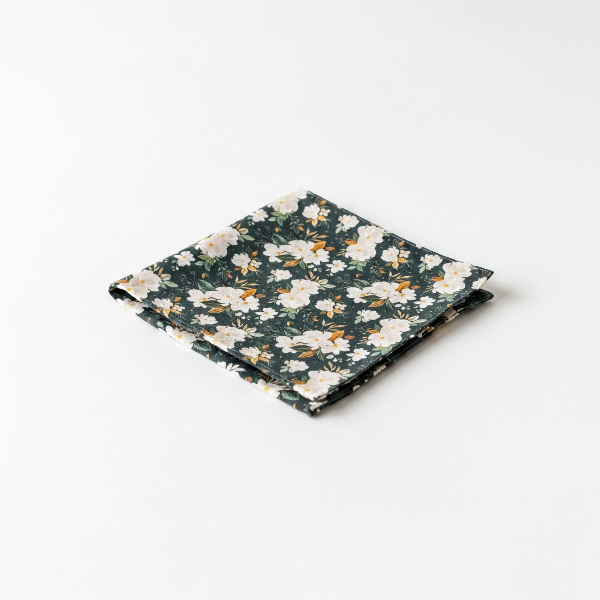 A square-shaped handkerchief with a floral pattern in shades of green and white.