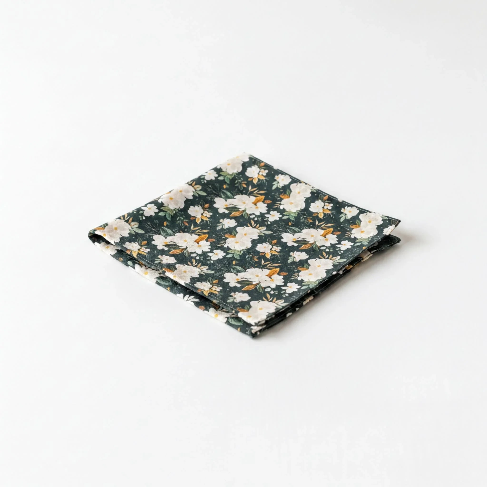 A square-shaped handkerchief with a floral pattern in shades of green and white.