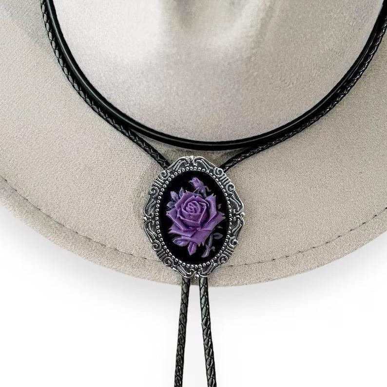 Bolo Tie- Black & Purple Rose on silver bezel with black leather cord on a gray cowboy hat.