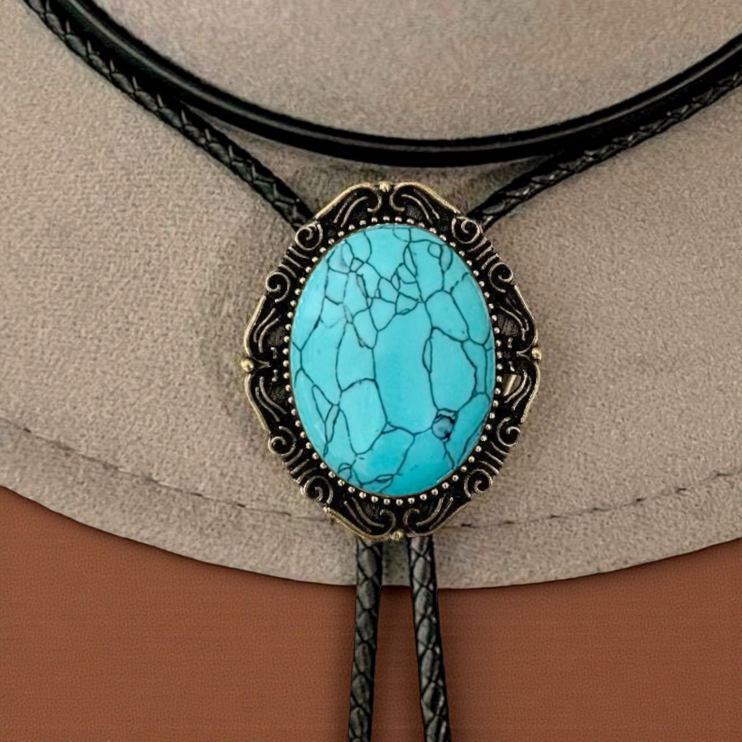 Turquoise stone bolo tie on a beige and brown background
