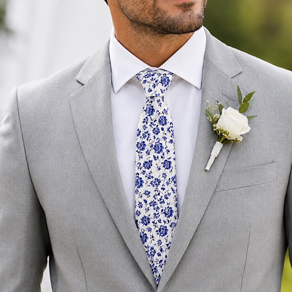 Groomsman in a blue floral tie and gray suit.