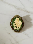Lily of the valley brooch with brass setting and silver pin back.