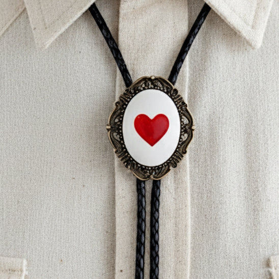 Bolo tie with a red heart design on a beige shirt worn by a man