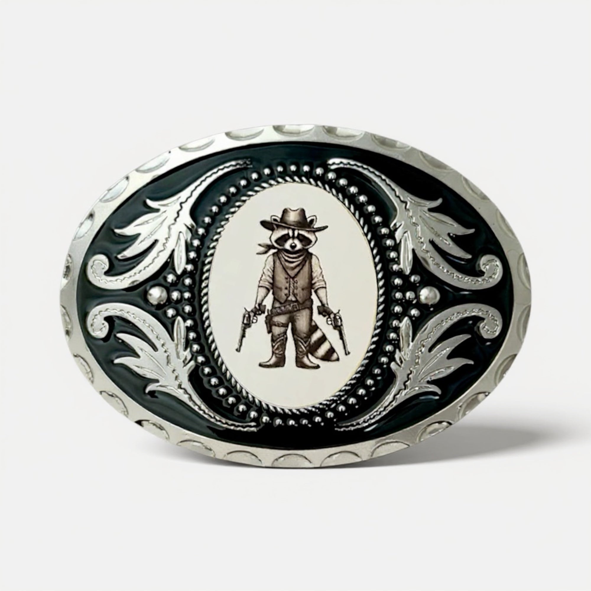 Decorative funny raccoon belt buckle with a raccoon wearing a cowboy hat and holding guns on a black background.