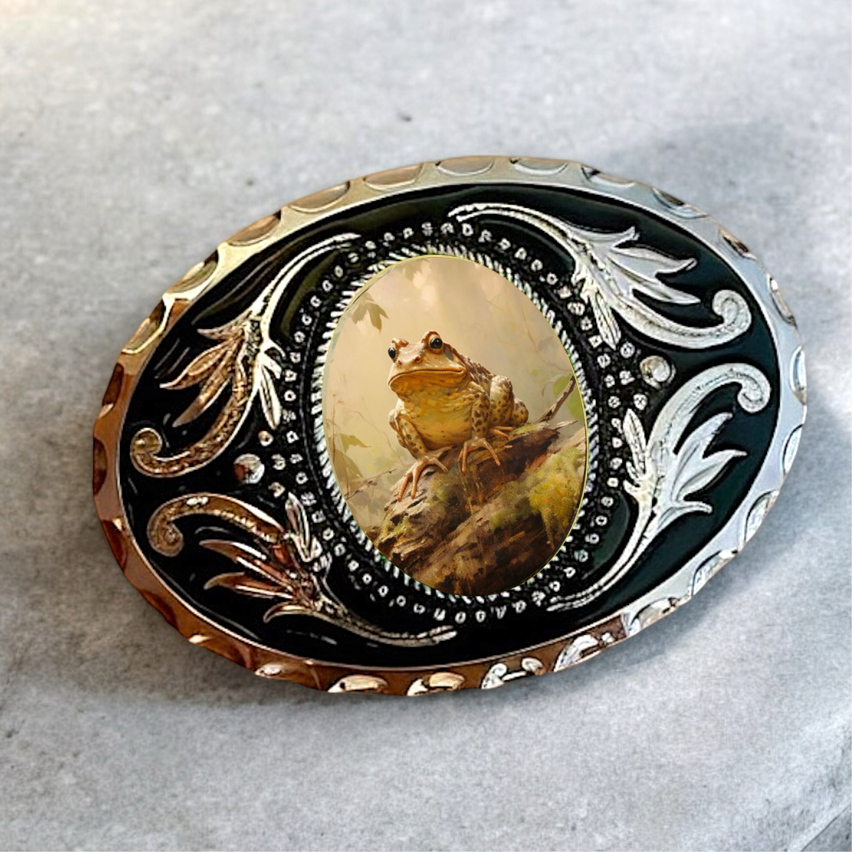 Belt buckle with frog design and intricate metalwork on a white background