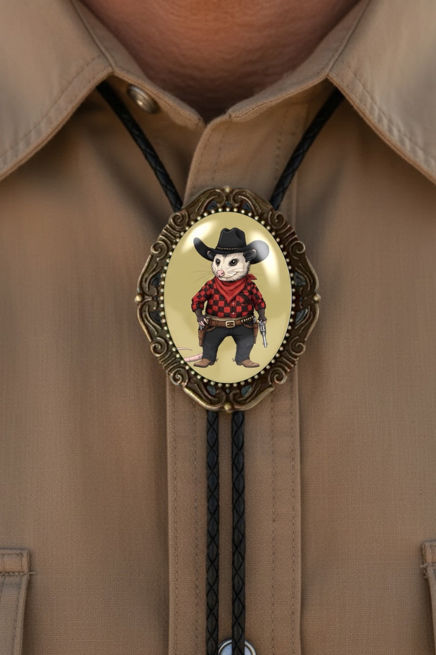 Opossum bolo tie with a skull wearing a cowboy hat and red plaid shirt on a beige shirt background