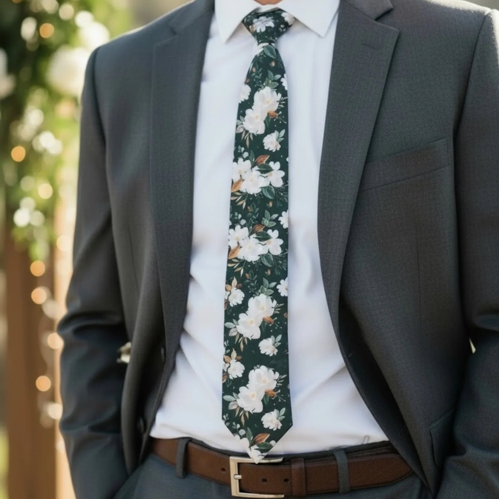 Emerald floral mens tie worn by a groomsman at a wedding.
