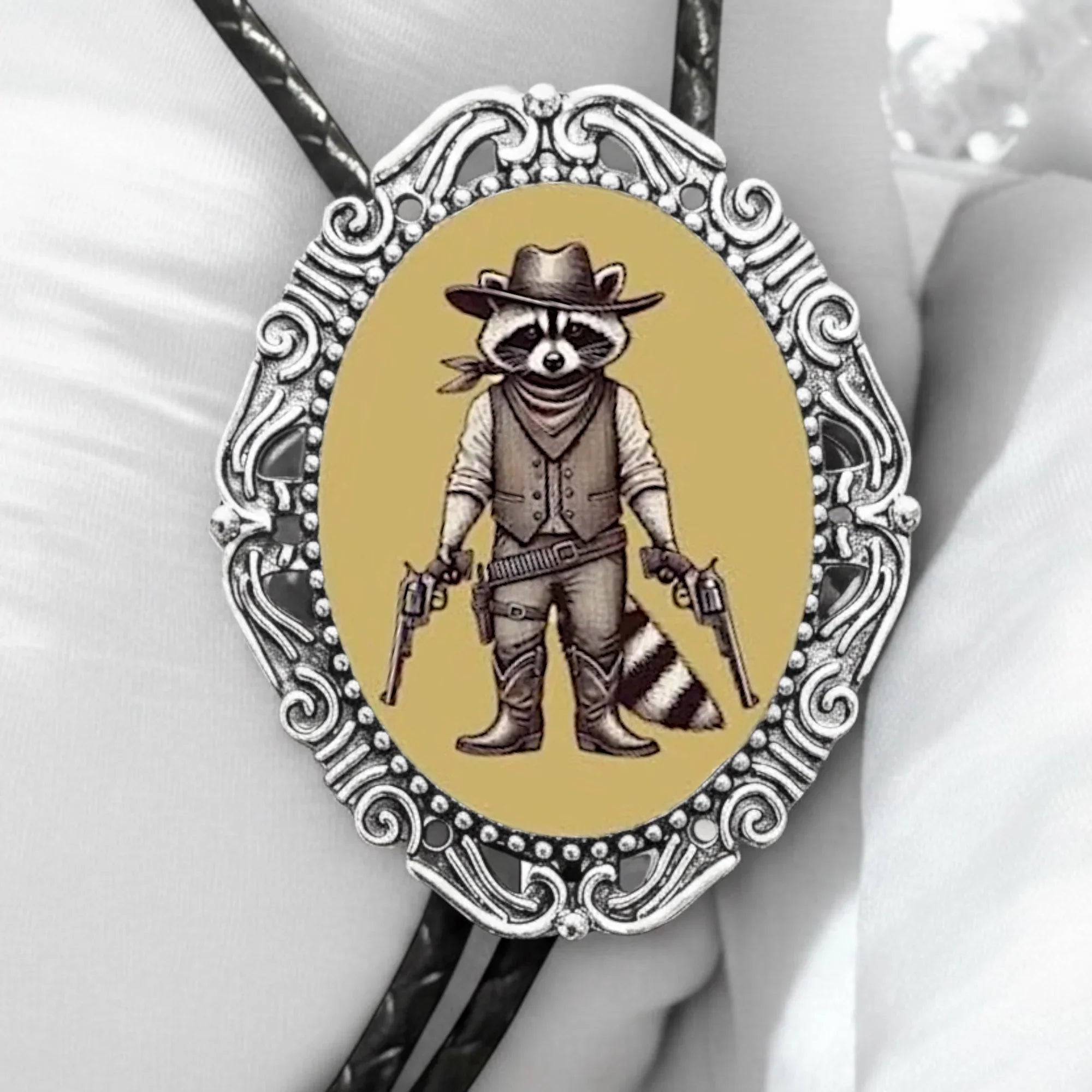 Raccoon bolo tie with leather cord.