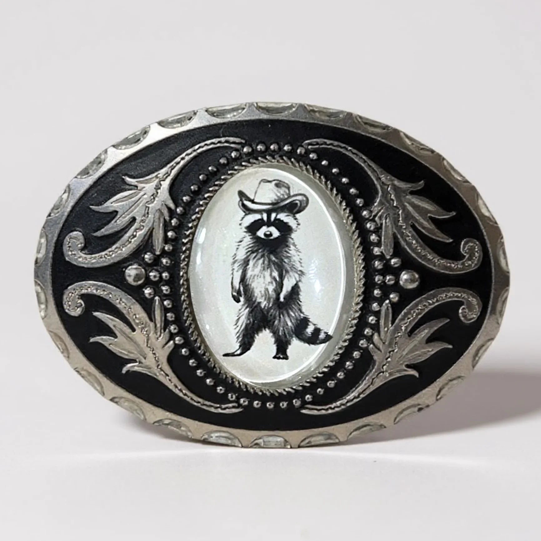 Raccoon Belt buckle with raccoon illustration wearing a cowboy hat on a white background