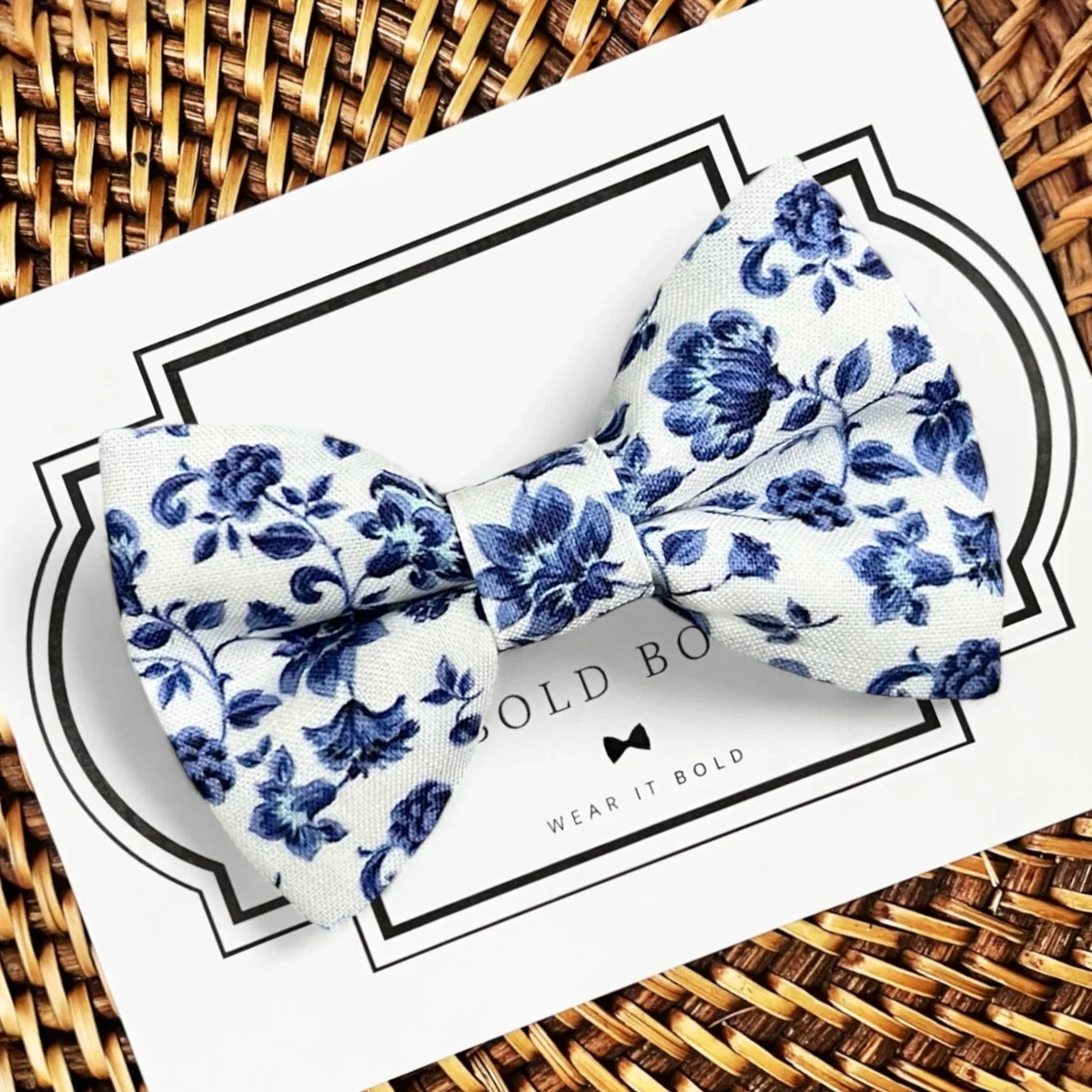 Floral Dog Bow Tie in Blue and White on a Woven Tray.