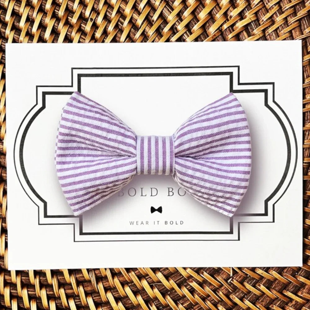 Lavender striped seersucker bow tie for dogs or cats on a white presentation card.
