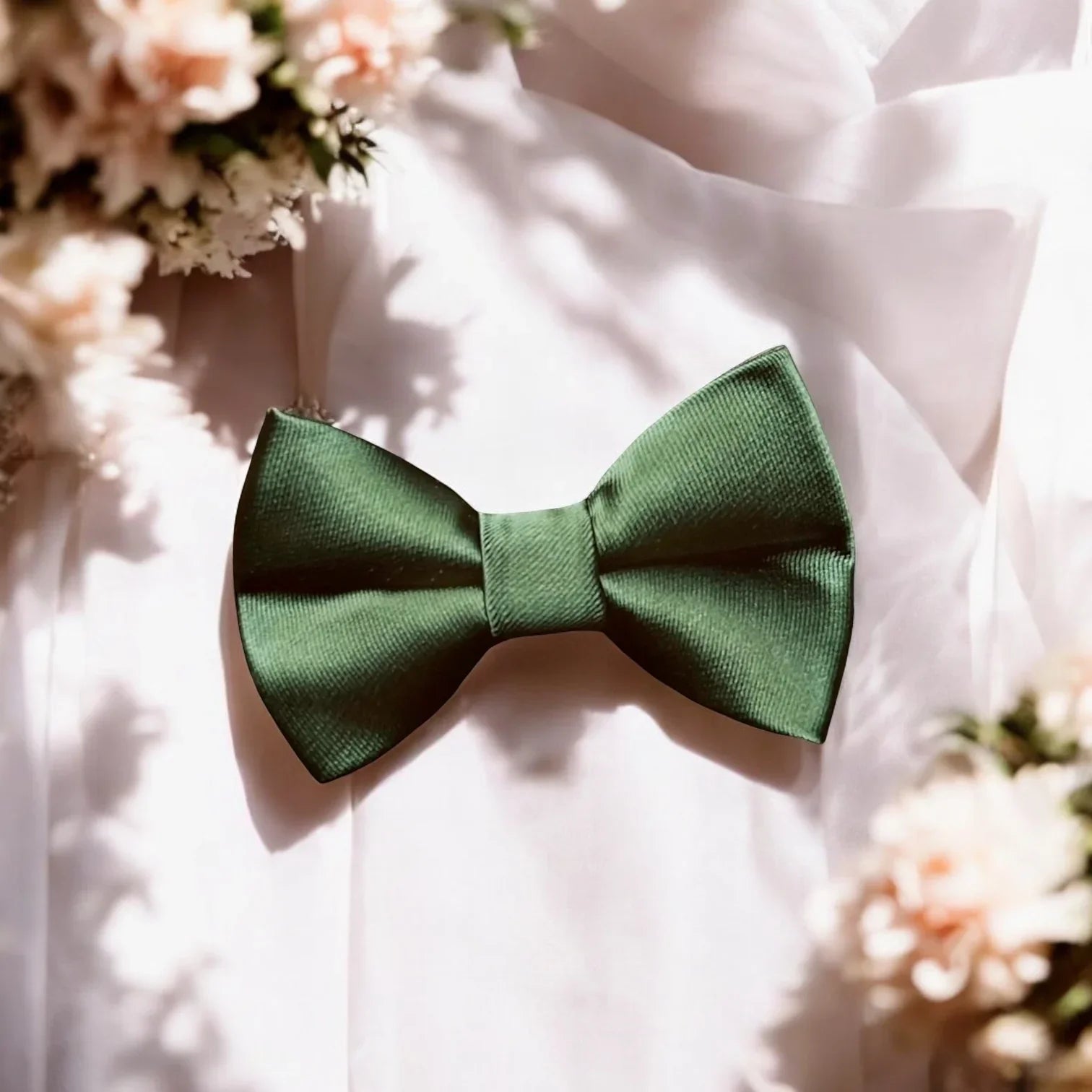 Size chart for pre-tied bow ties from The Bold Bow Tie detailing measurements across three sizes. Small is 3.5 inches wide and recommended for ages 6 months to 5 years. Medium is 4 inches wide and recommended for ages 6 to 12 years. Large is 4.5 inches wide and recommended for ages 13 years and up. Visual icons illustrate the relative sizes with horizontal arrows showing that width is measured from wingtip to wingtip. Bottom text notes that all bow ties are pre-tied and ready to add to your outfit.