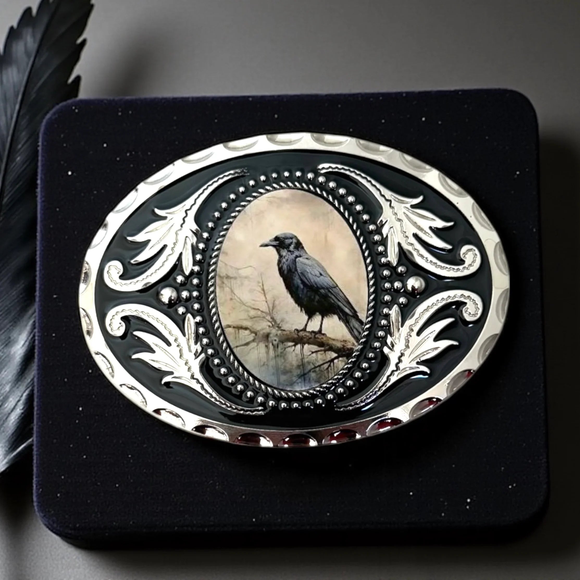 Decorative belt buckle with a bird design on a black background
