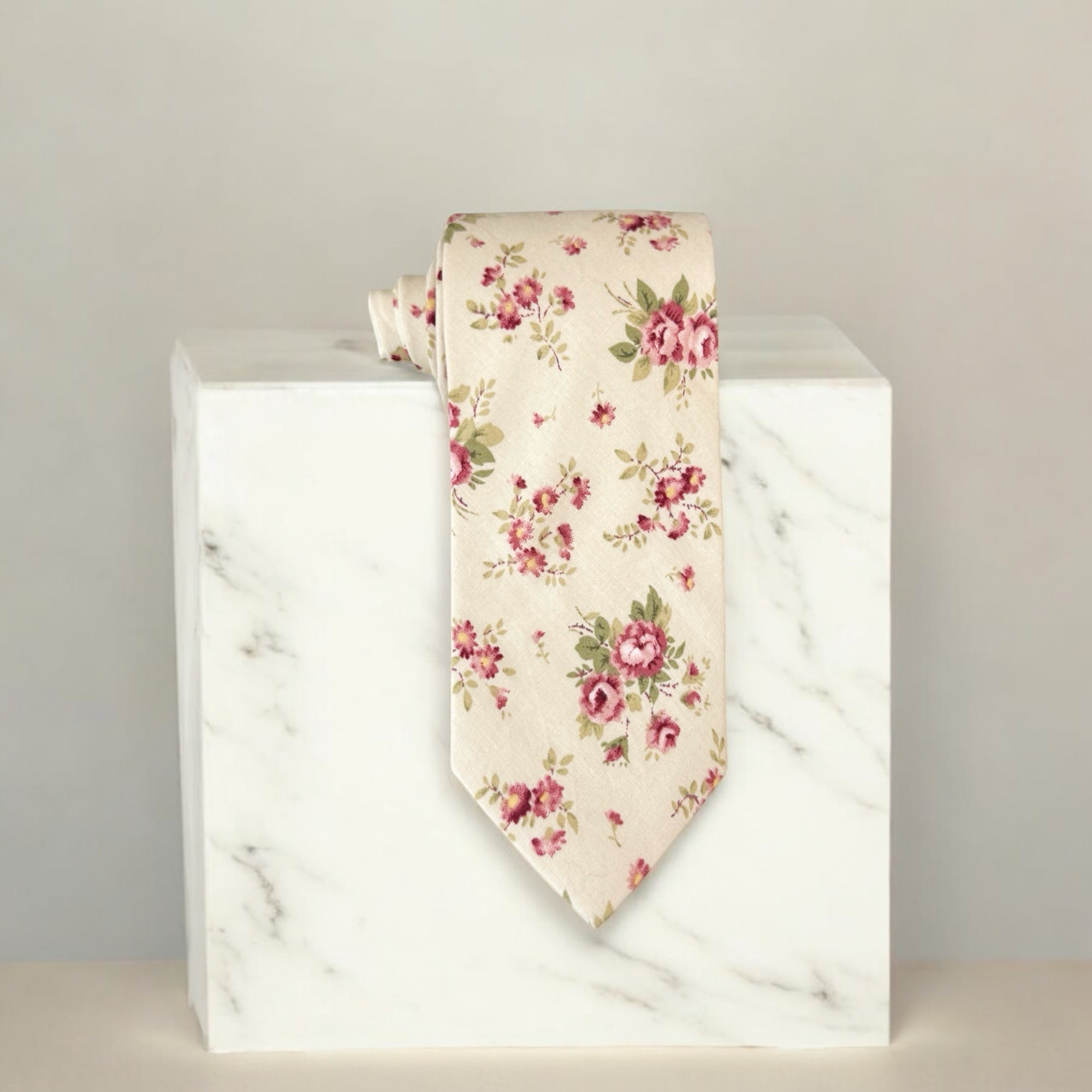 Floral tie on a marble block with a neutral background