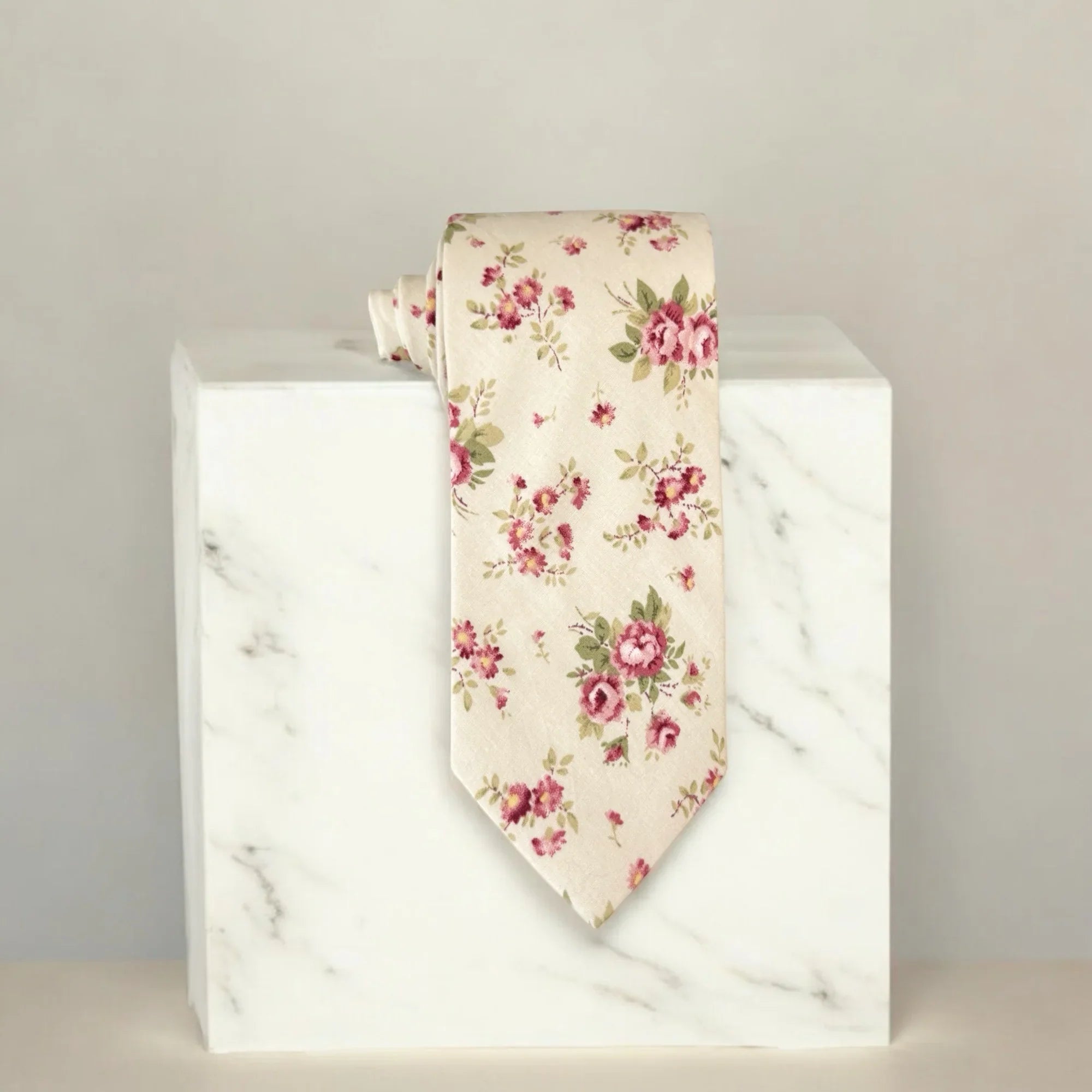 Floral tie on a marble block with a neutral background