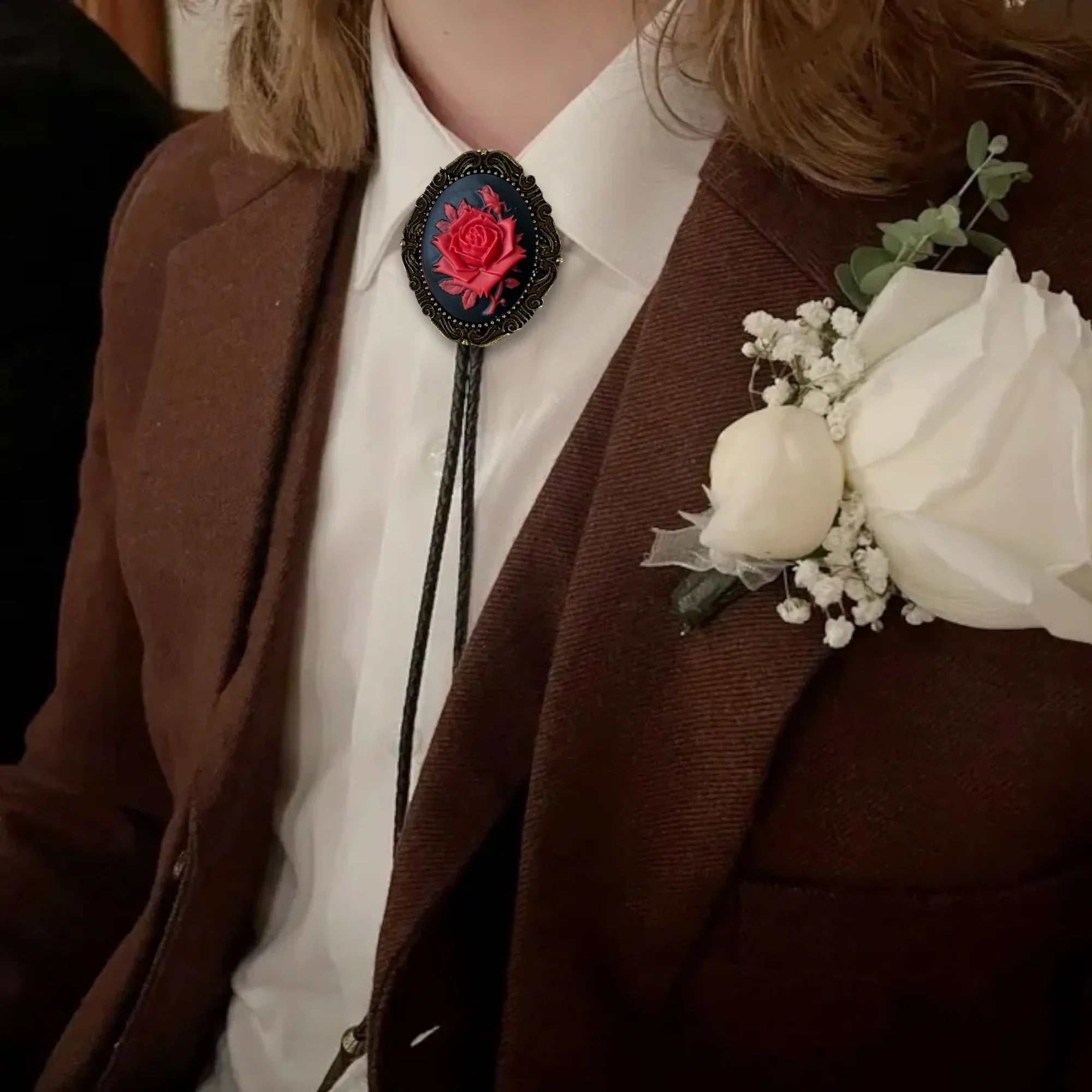 Brass bolo tie clip on a wooden surface