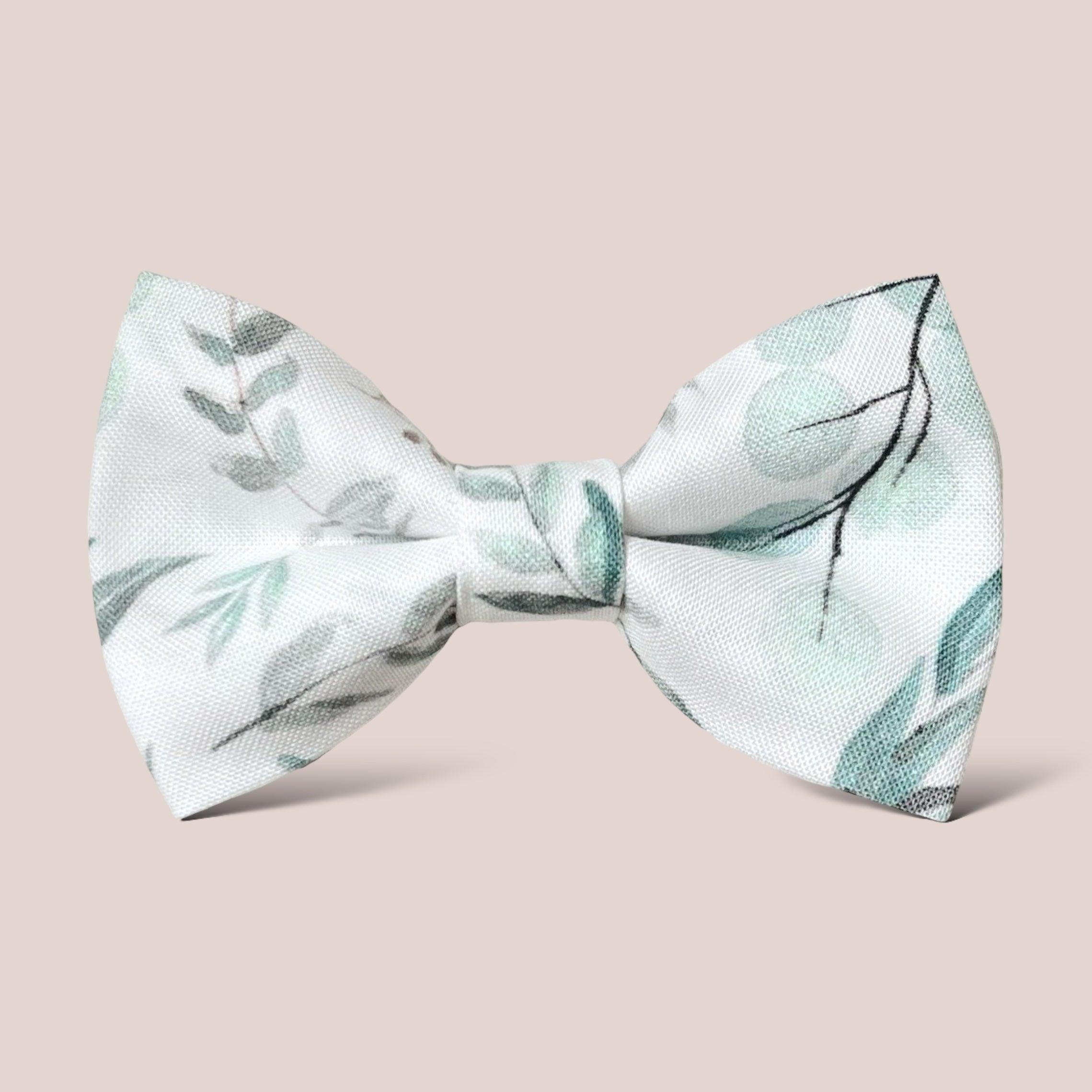 a white bow tie with green leaves on it