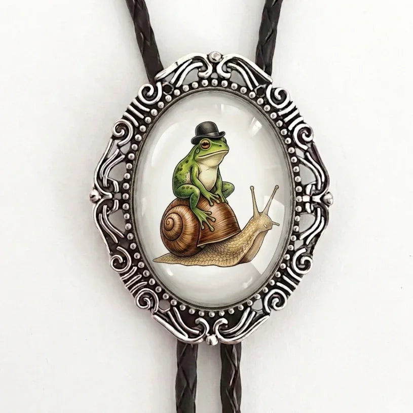 Bolo tie with frog and snail in silver and black leather cord.
