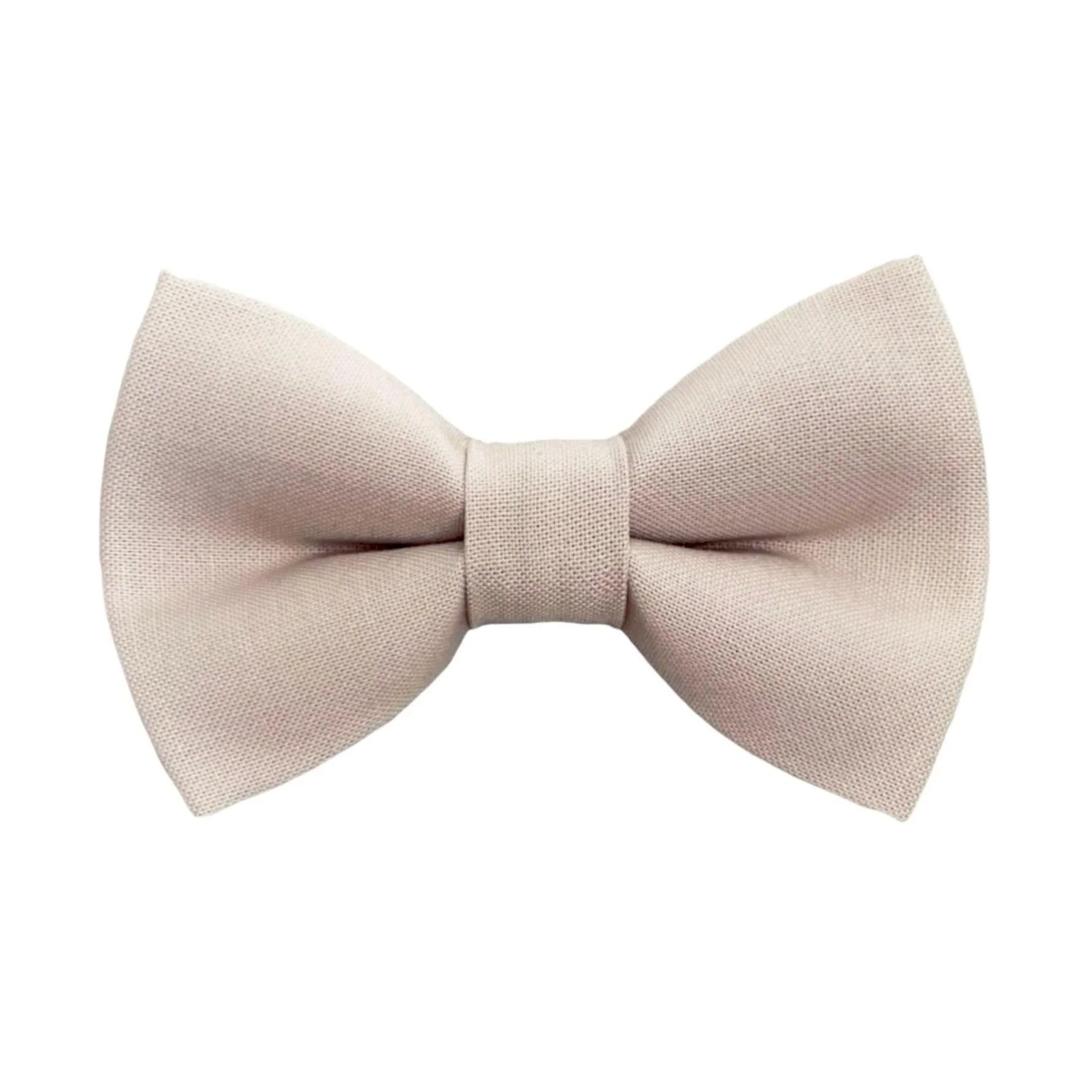 Size chart for pre-tied bow ties from The Bold Bow Tie detailing measurements across three sizes. Small is 3.5 inches wide and recommended for ages 6 months to 5 years. Medium is 4 inches wide and recommended for ages 6 to 12 years. Large is 4.5 inches wide and recommended for ages 13 years and up. Visual icons illustrate the relative sizes with horizontal arrows showing that width is measured from wingtip to wingtip. Bottom text notes that all bow ties are pre-tied and ready to add to your outfit.