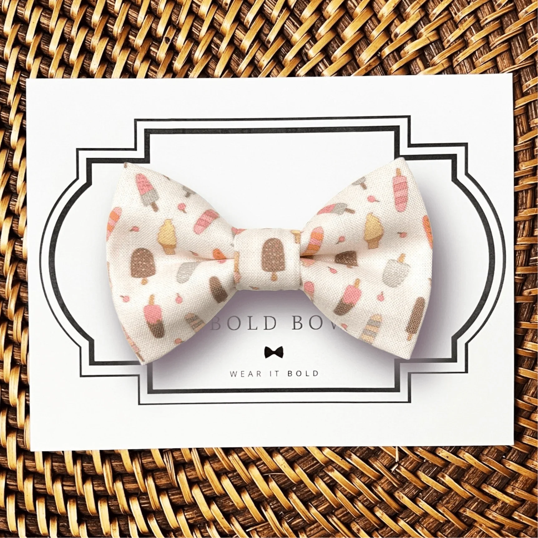Ice cream patterned cream bow tie for dog or cat collar displayed on a white boxed backdrop.