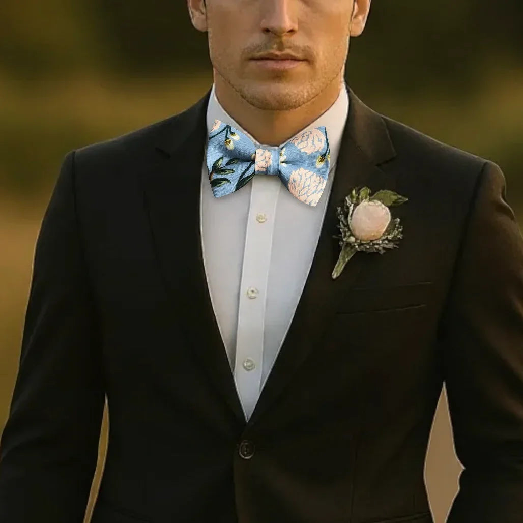 Dusty blue hydrangea bow tie worn by a groomsman in a wedding party.