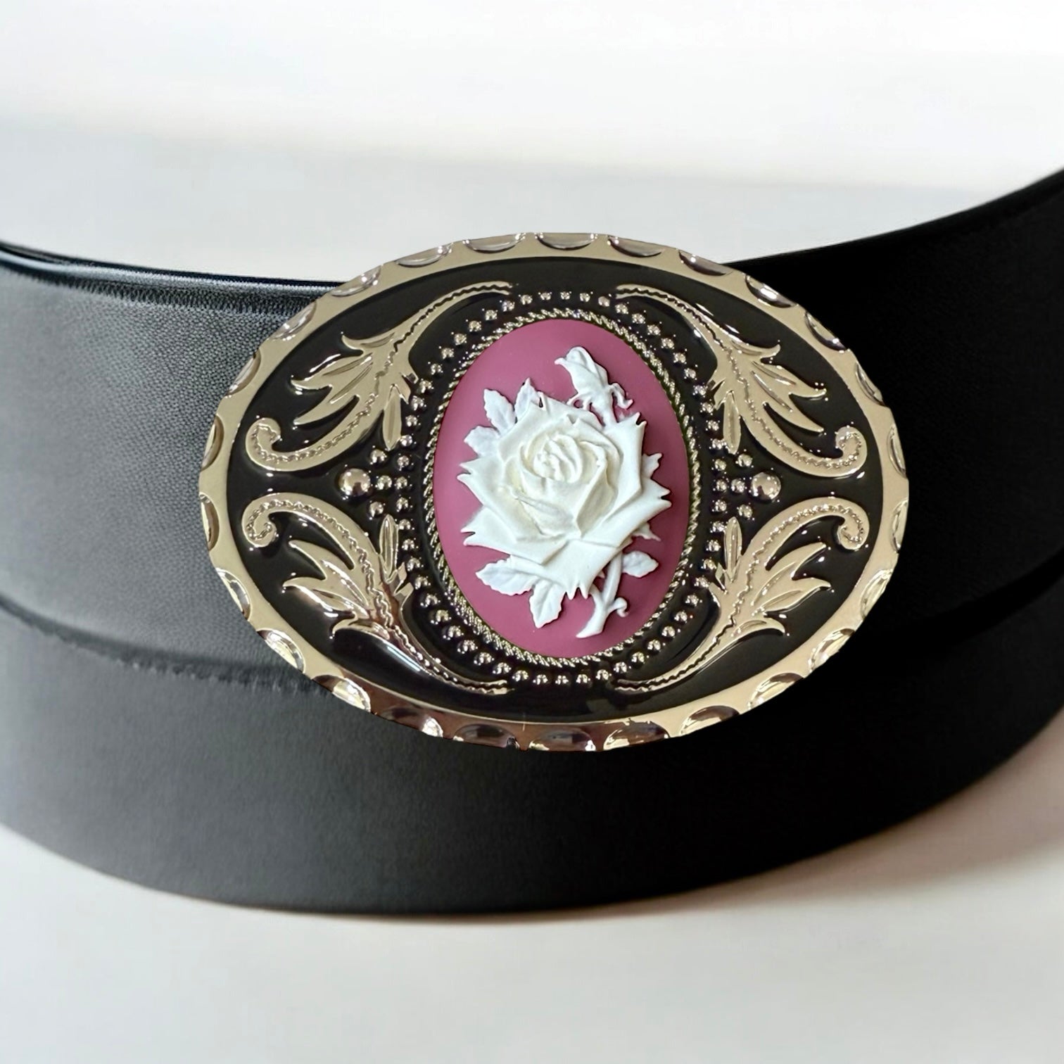 Black belt with a decorative buckle featuring a white rose design on a white background